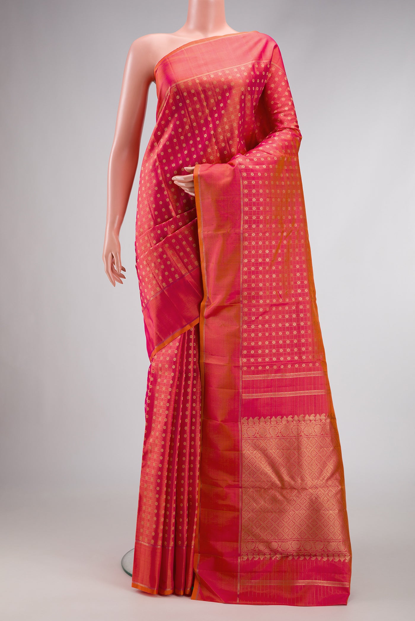 Pure Silk Pure Zari Coral Dual Tone Kanchipuram Saree with Zari Butta on the body and Zari Border.  displayed on a mannequin