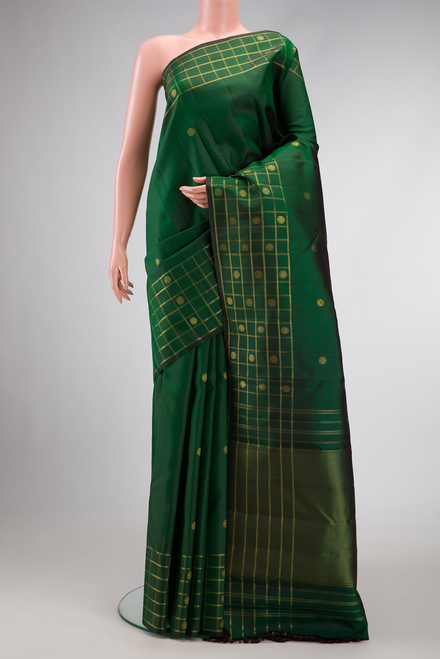 Pure Silk Pure Zari Green Dual Tone Kanchipuram Saree with Zari Butta on the body and Zari Border.  displayed on a mannequin