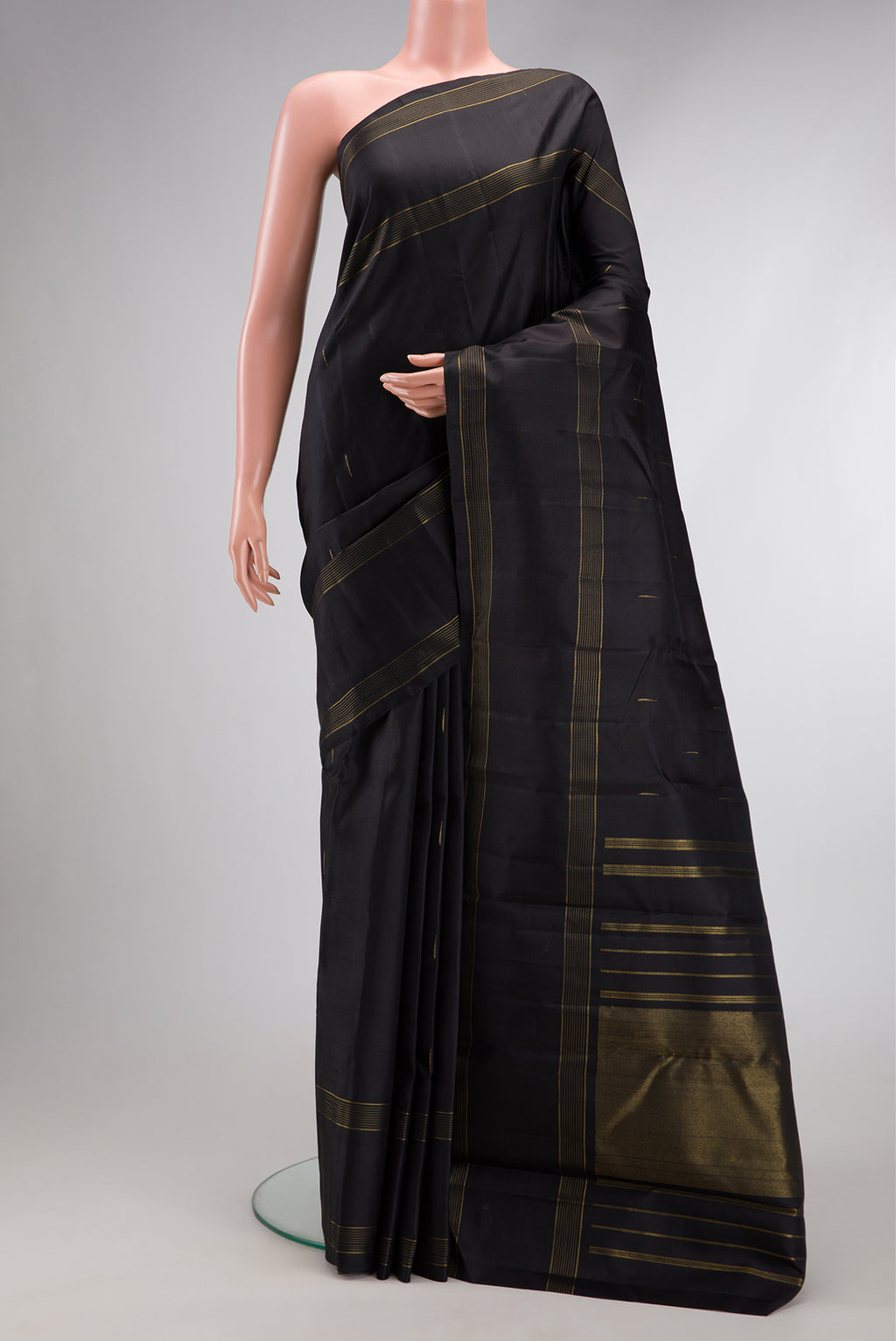 Pure Silk Pure Zari Black Dual Tone Kanjivaram Saree with Zari Butta on the body and Zari Border.  displayed on a mannequin