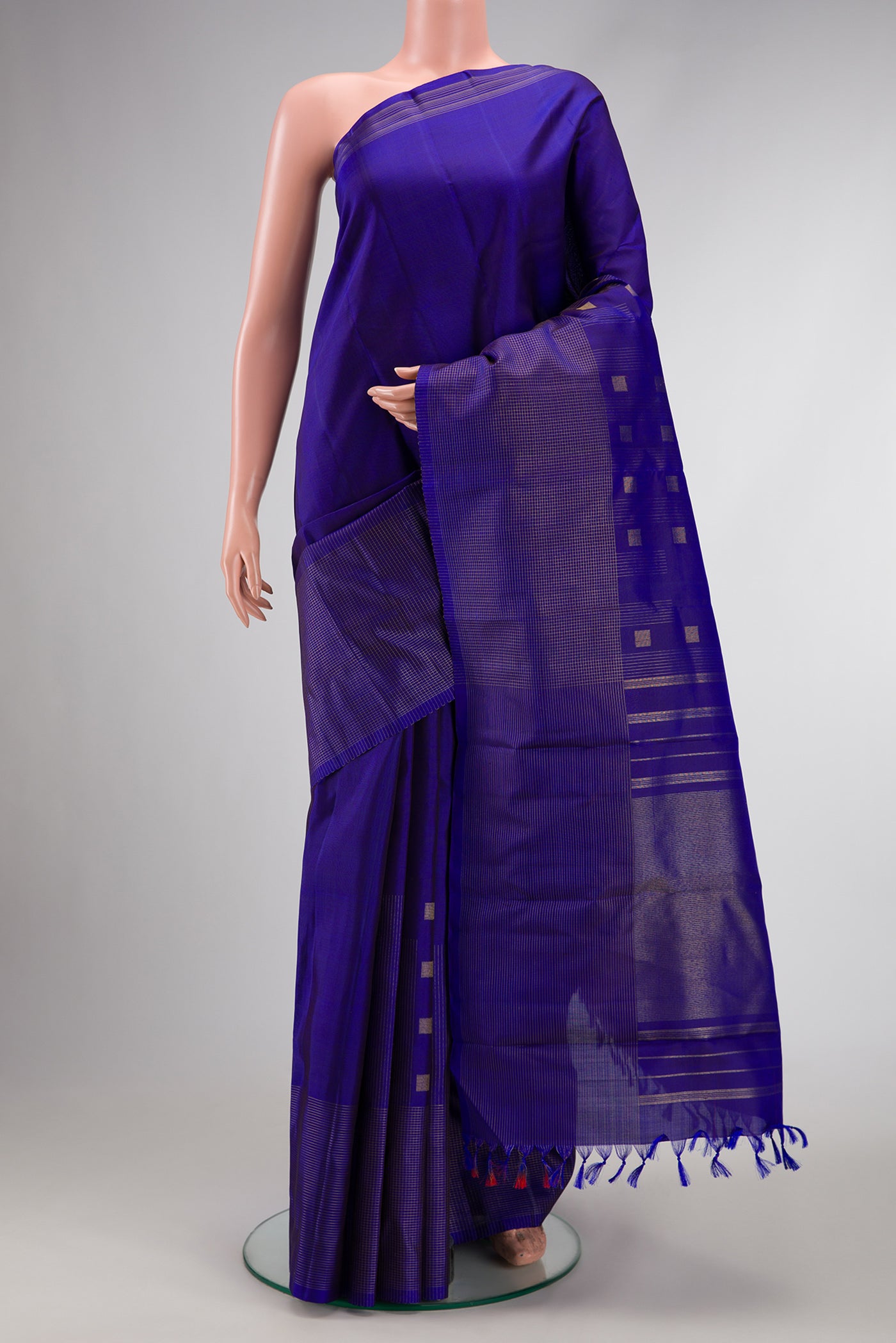 Pure Silk Pure Zari Royal Blue Dual Tone Kanchipuram Saree with Zari Butta on the body and Fancy Border.  displayed on a mannequin