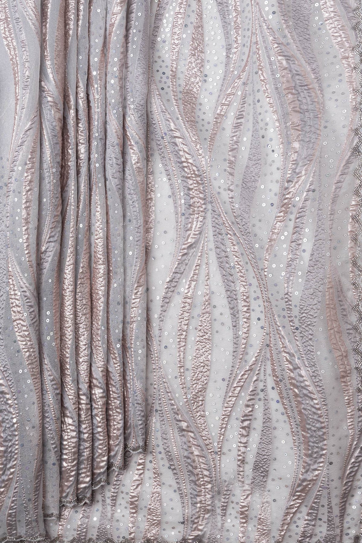 Pleats and pallu of Grey Dual Tone Organza Silk Saree with Embroidery on the body and Embroidery Border. 