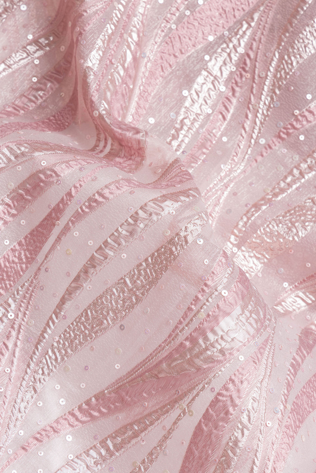 Close up of Rose Gold Dual Tone Organza Silk Saree with Embroidery on the body and Embroidery Border.  displaying folds