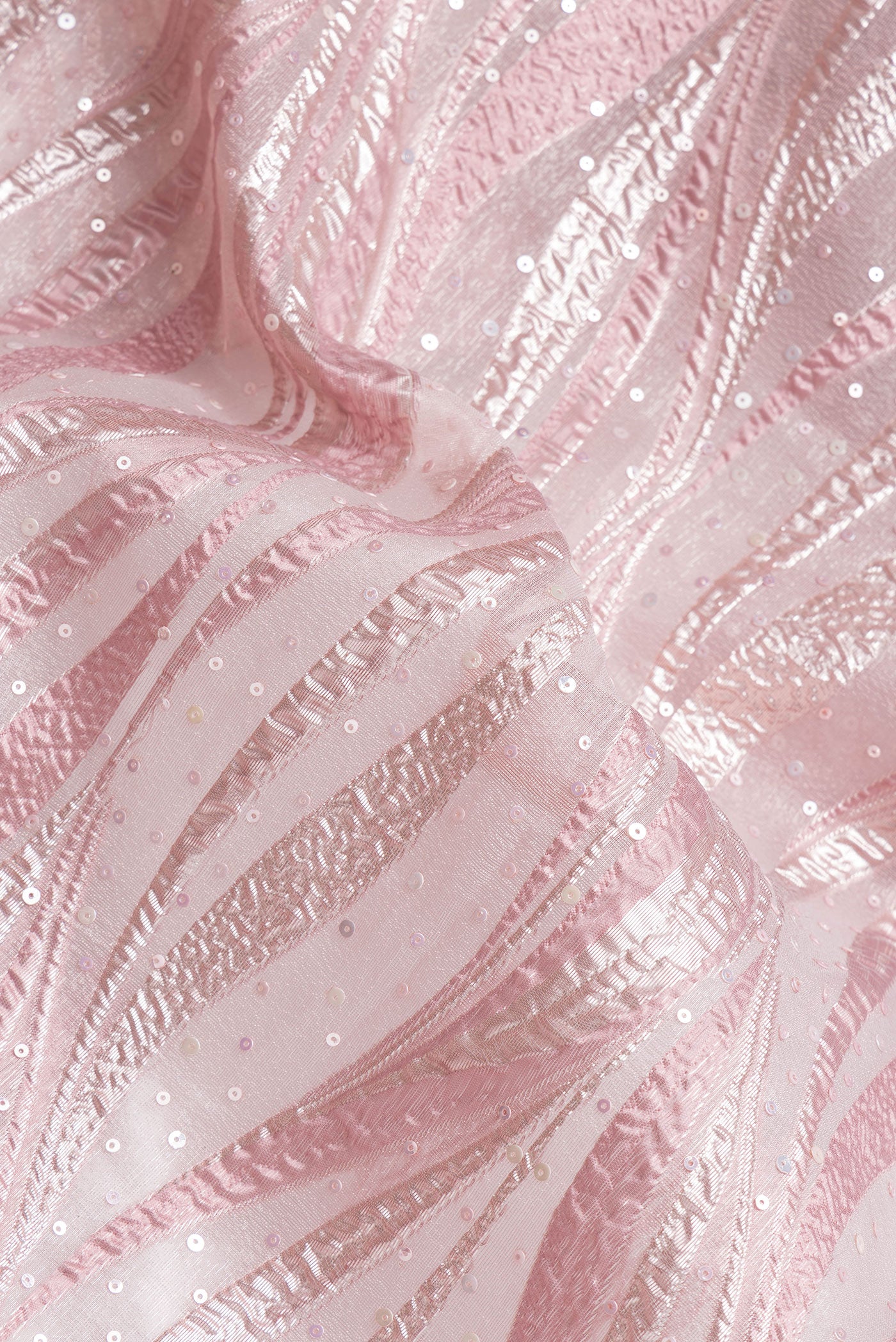 Close up of Rose Gold Dual Tone Organza Silk Saree with Embroidery on the body and Embroidery Border.  displaying folds