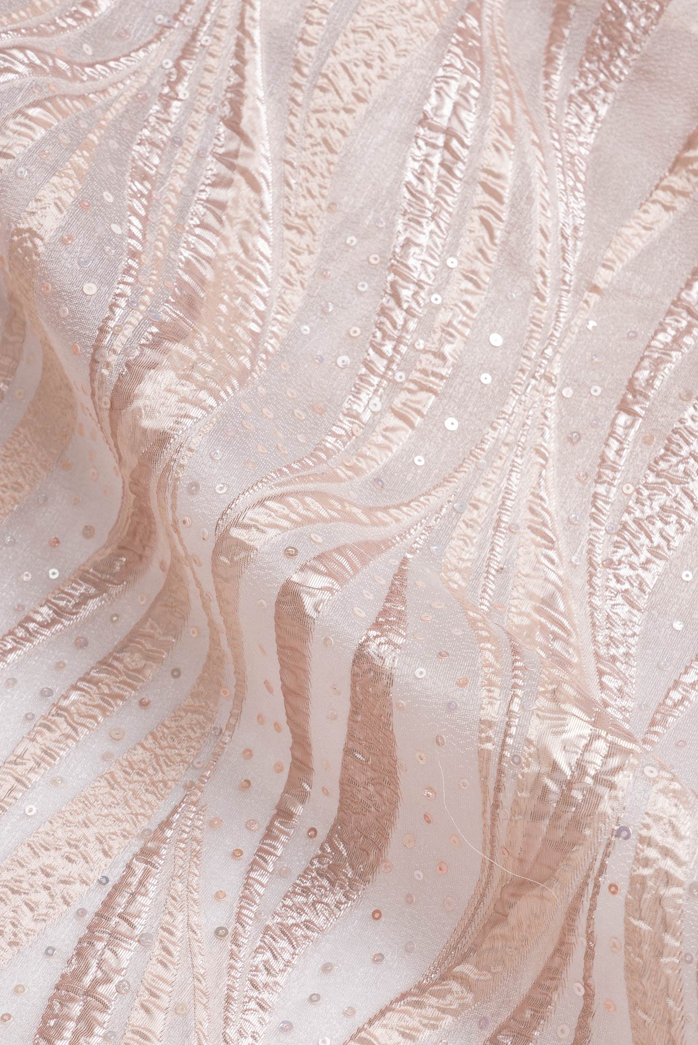 Close up of Gold Dual Tone Organza Silk Saree with Embroidery on the body and Embroidery Border.  displaying folds