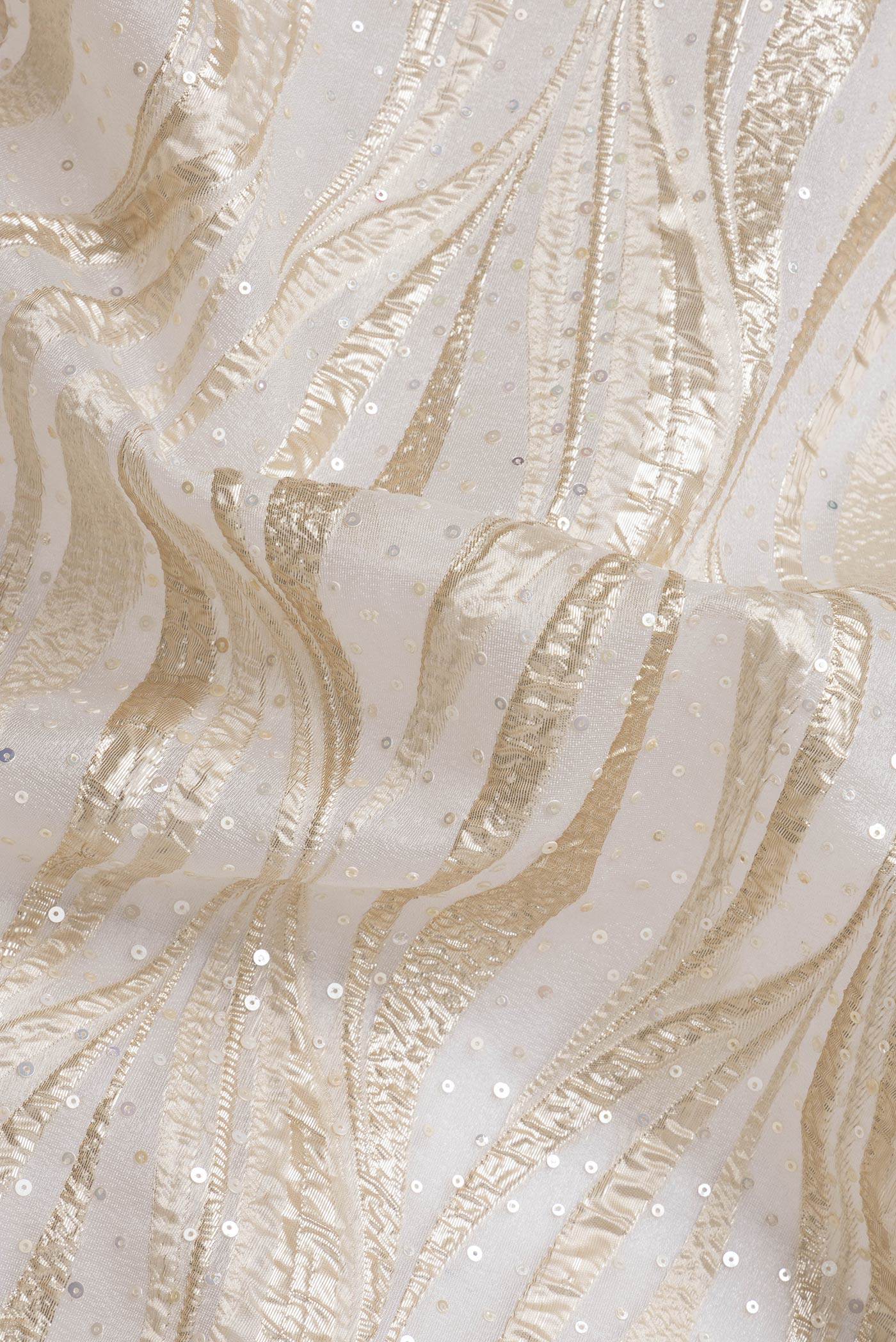 Close up of Gold Dual Tone Organza Silk Saree with Embroidery on the body and Embroidery Border.  displaying folds