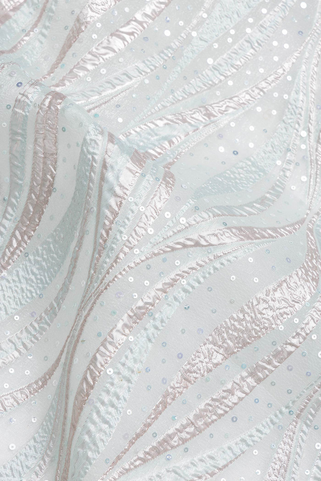 Close up of Sea Green Dual Tone Organza Silk Saree with Embroidery on the body and Embroidery Border.  displaying folds