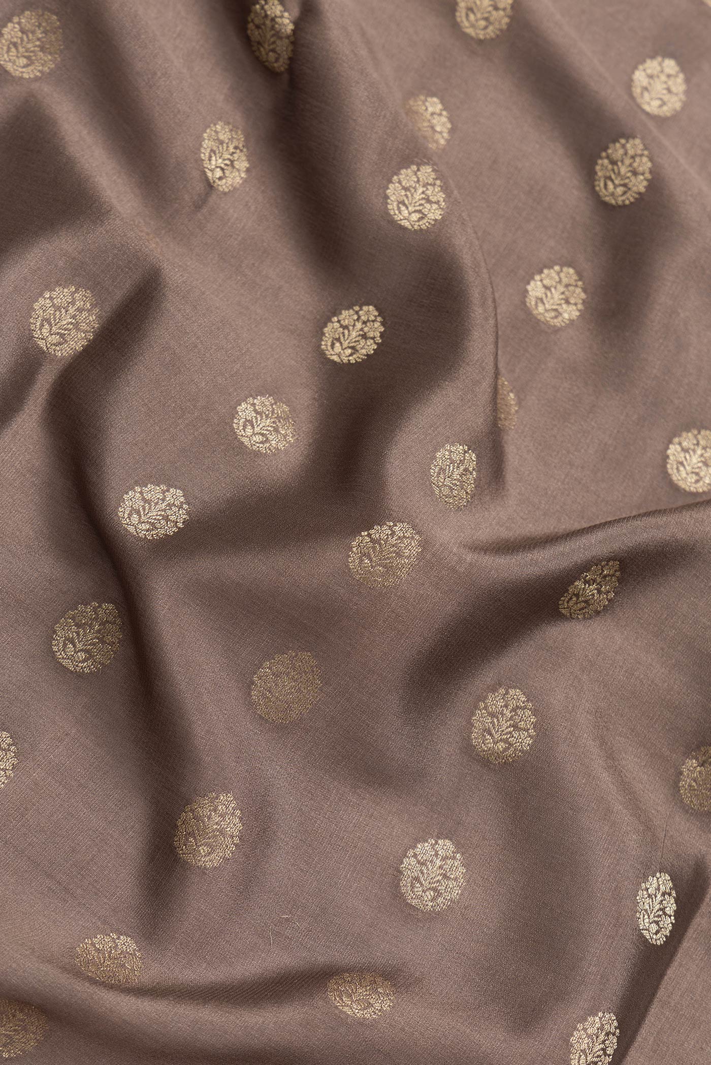 Close up of Brown Dual Tone Mysore Silk Saree with Zari Butta on the body and Fancy Border.  displaying folds