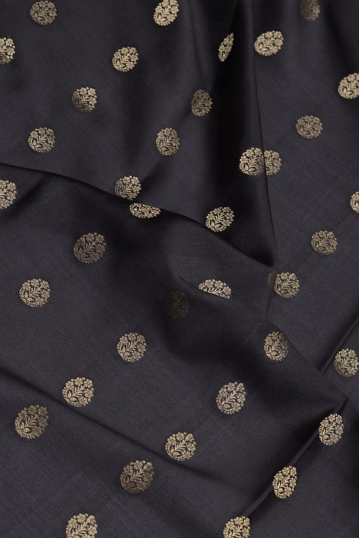 Close up of Black Mysore Crepe Saree with Zari Butta on the body and Fancy Border.  displaying folds
