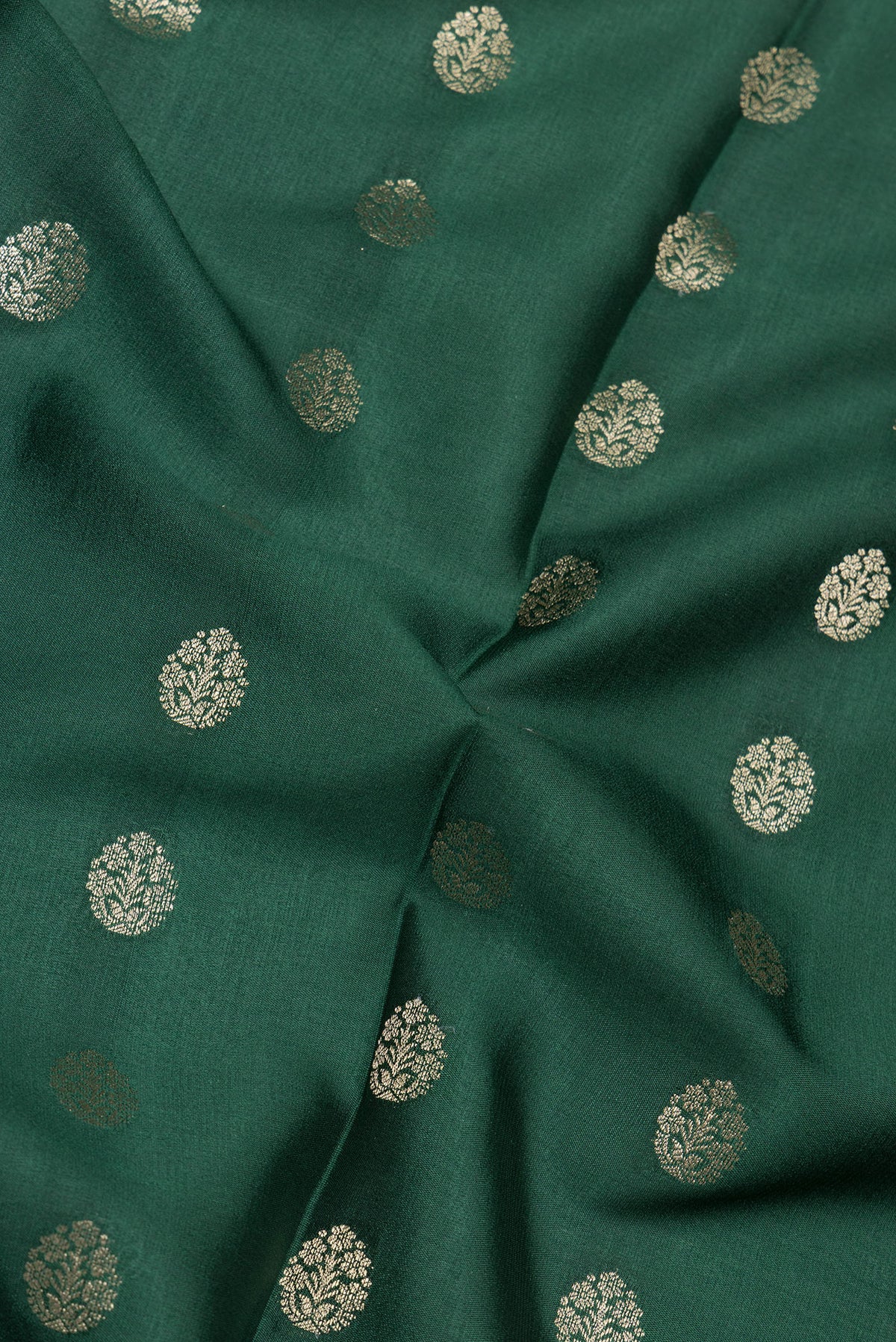 Close up of Bottle Green Mysore Silk Saree with Zari Butta on the body and Zari Border.  displaying folds