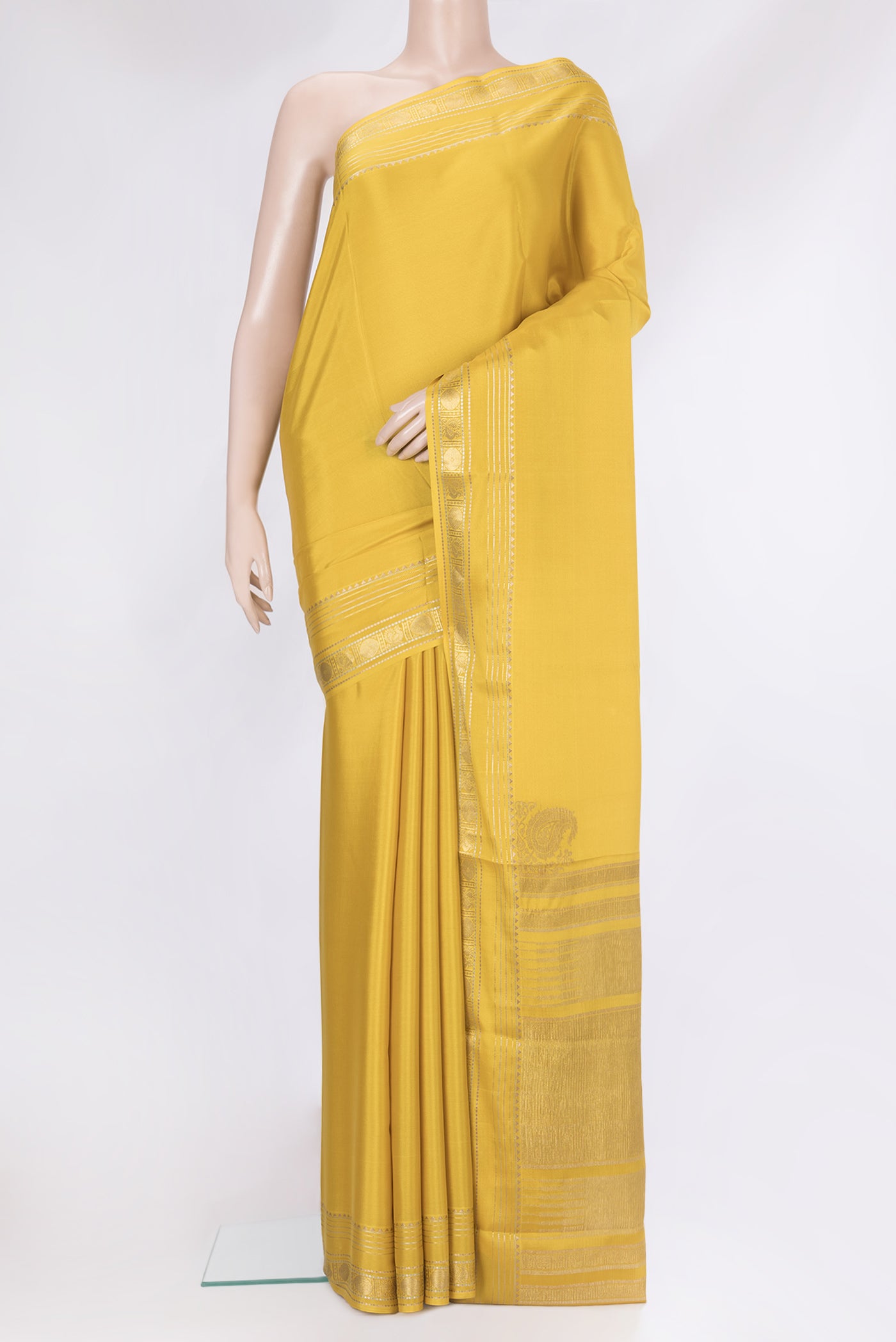 Mustard Mysore Silk Saree with Plain Body and Zari Border.  displayed on a mannequin