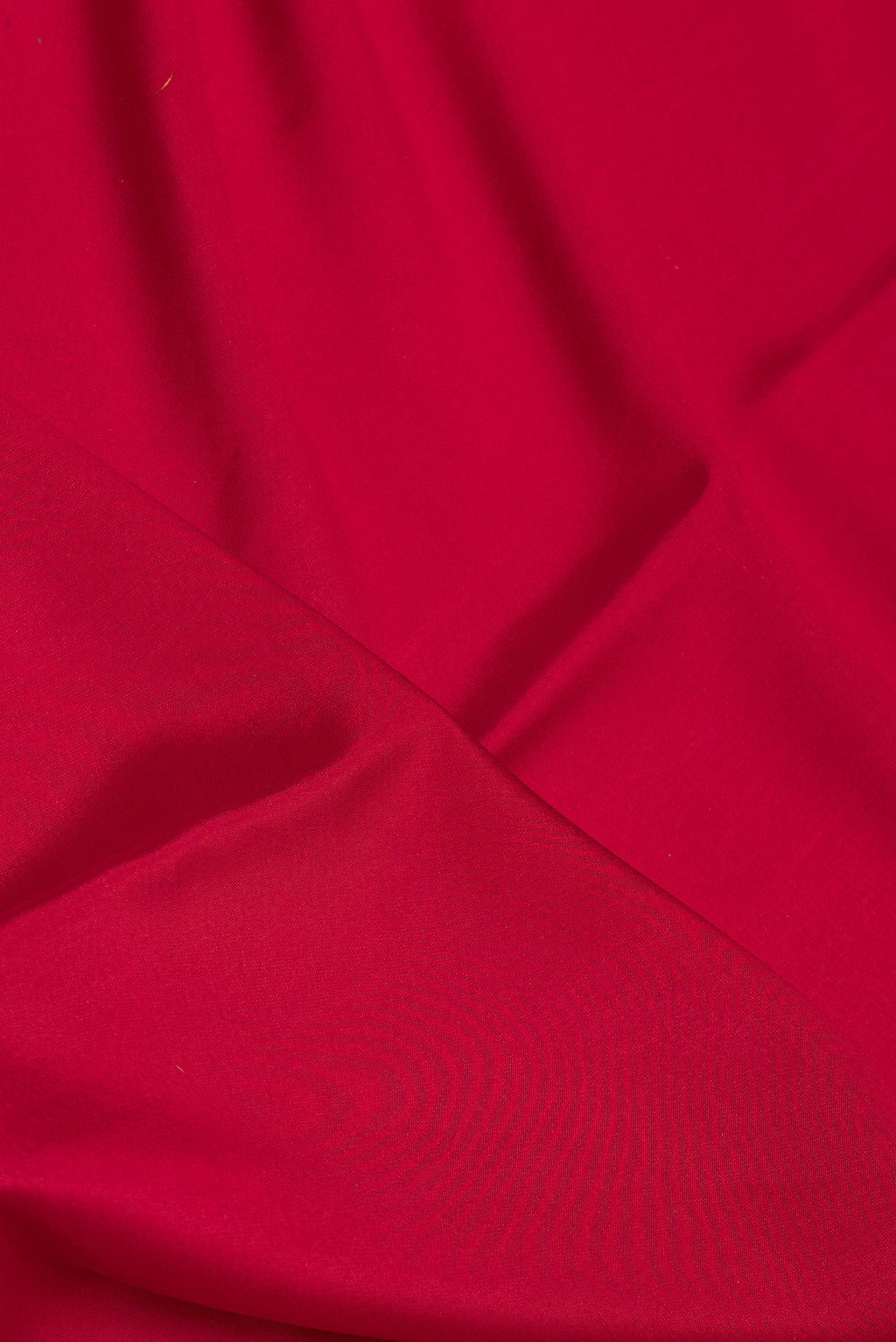 Close up of Deep Red Mysore Silk Saree with Plain Body and Zari Border.  displaying folds