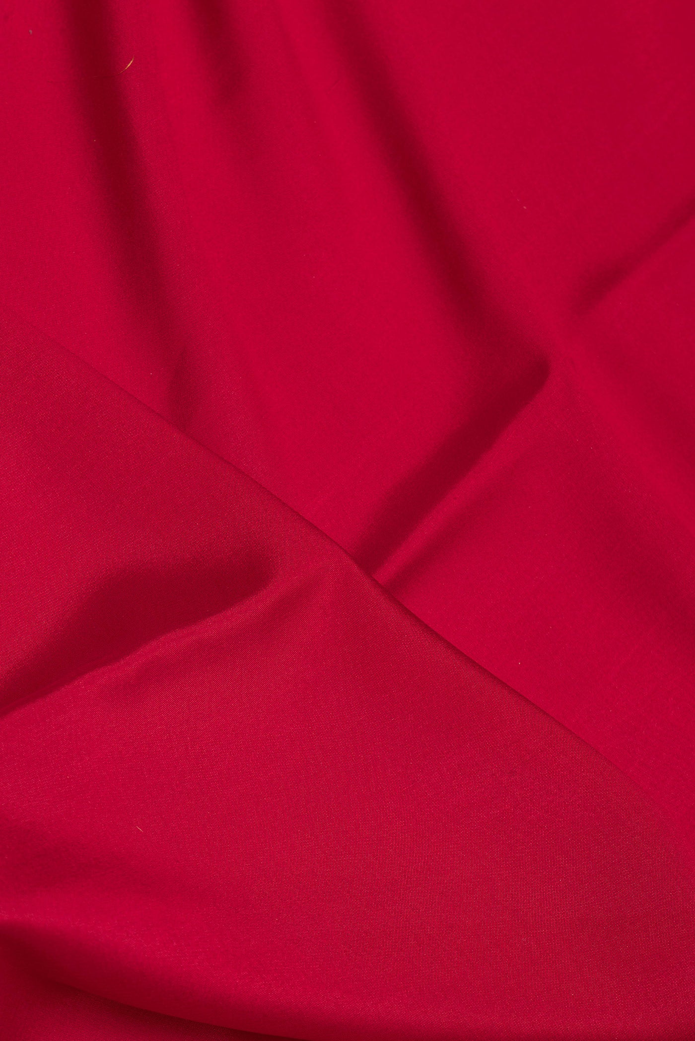 Close up of Deep Red Mysore Silk Saree with Plain Body and Zari Border.  displaying folds