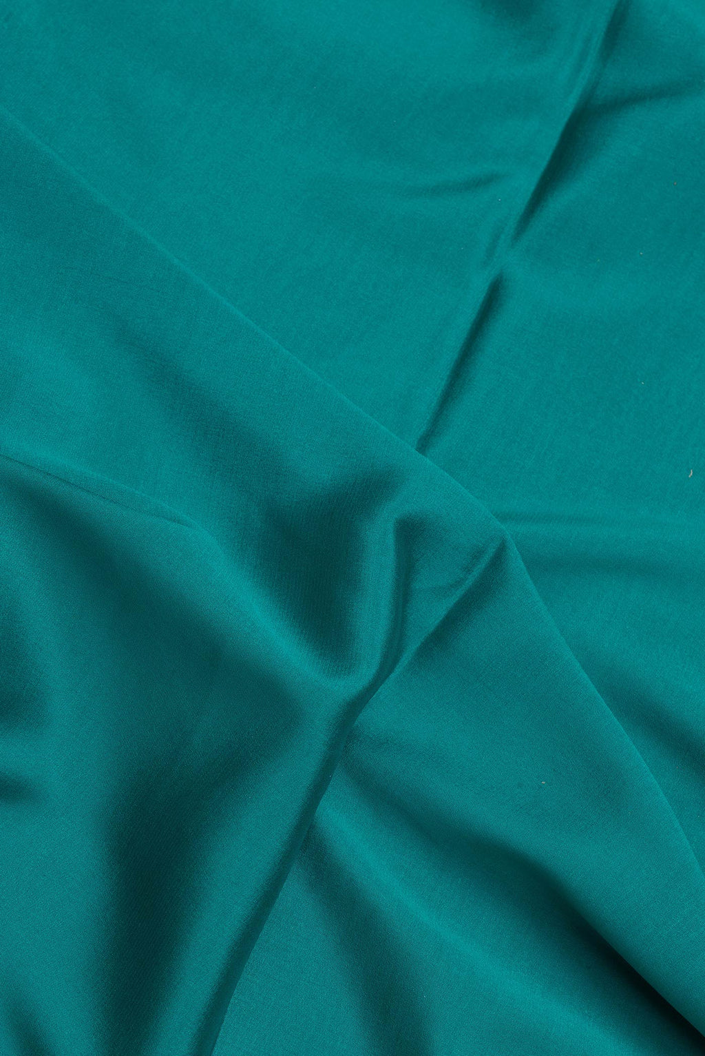 Close up of Sky Blue Dual Tone Mysore Silk Saree with Plain Body and Fancy Border.  displaying folds