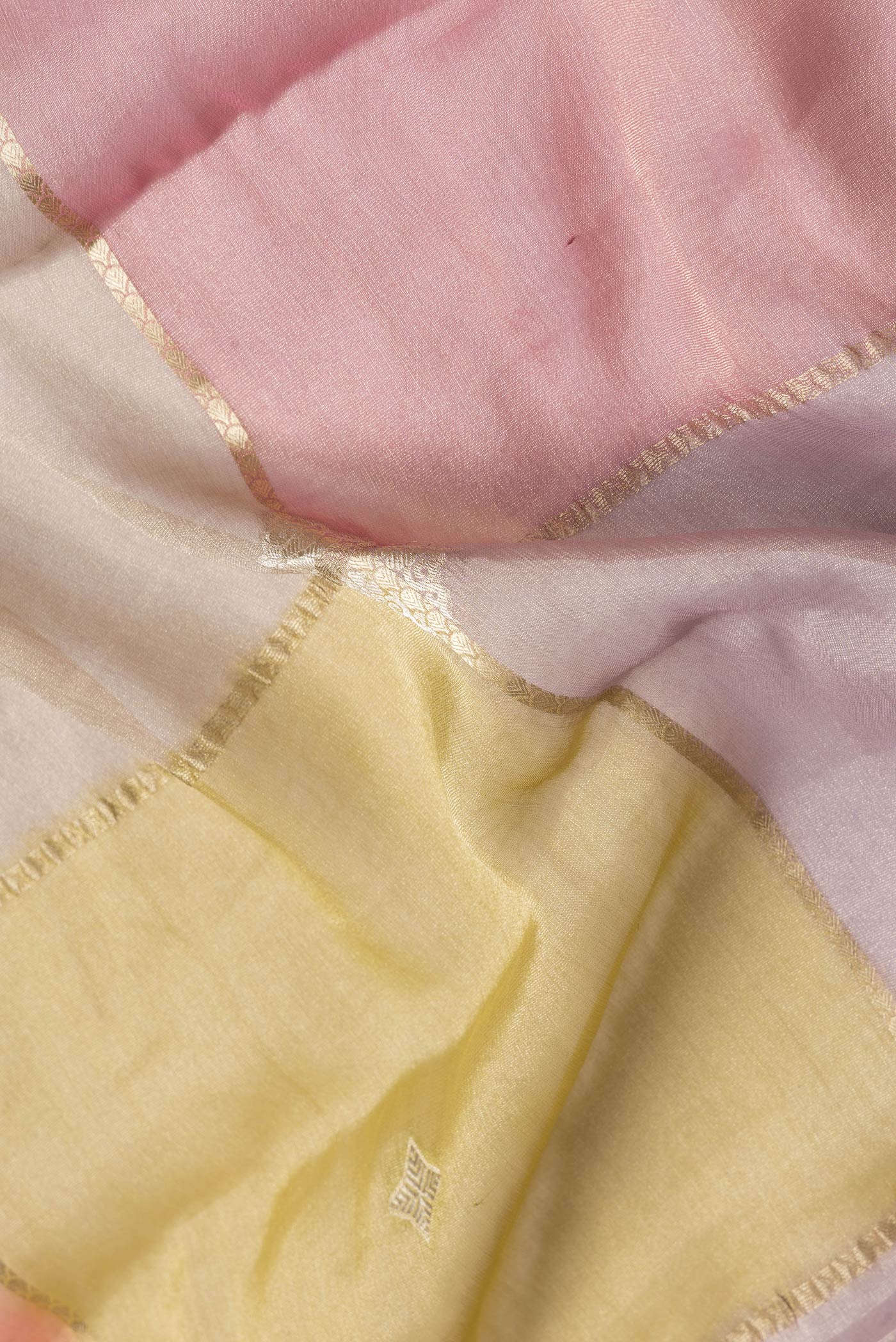 Close up of Yellow, Pink and Lavender Color Georgette Saree with Zari Brocade on the body and Zari Border.  displaying folds