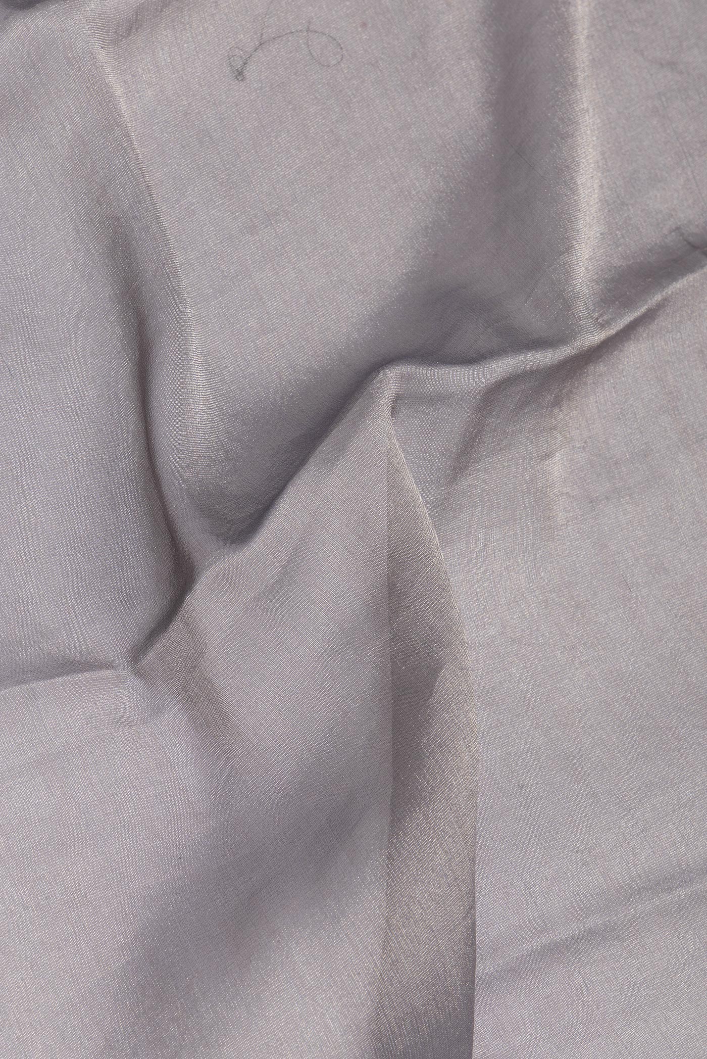 Close up of Grey Mysore Georgette Saree with Plain Body and Fancy Border.  displaying folds