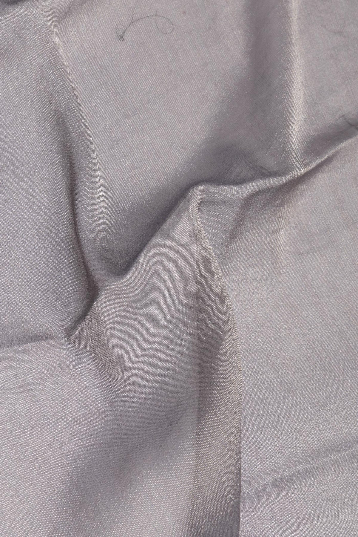 Close up of Grey Mysore Georgette Saree with Plain Body and Fancy Border.  displaying folds