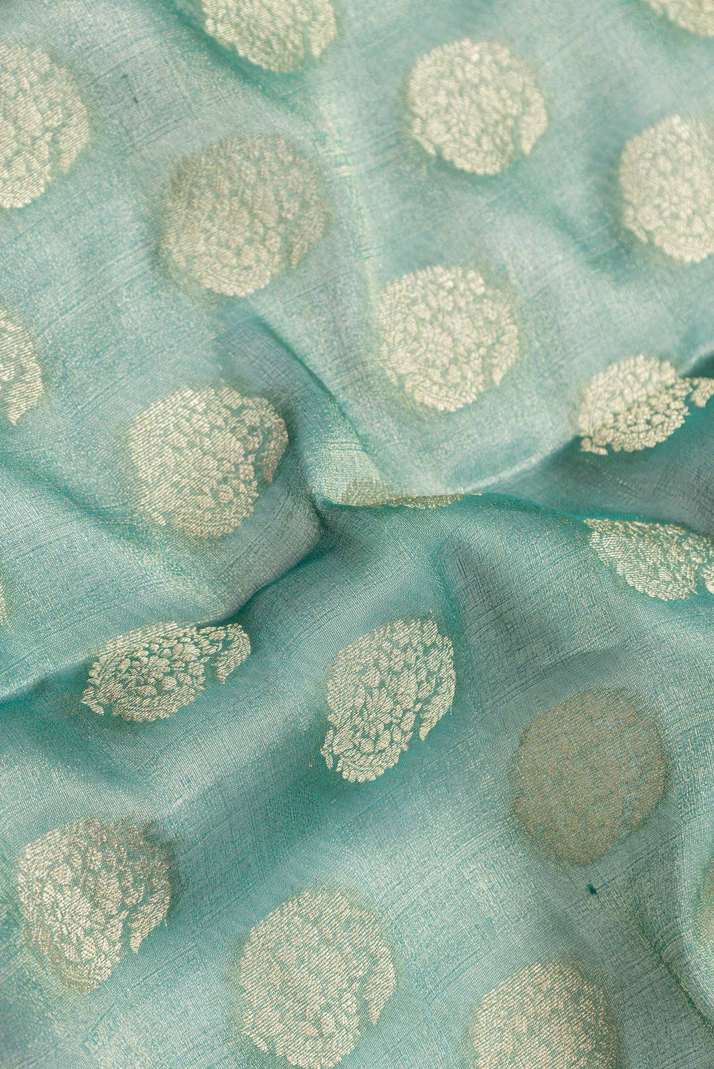 Close up of Sea Green Dual Tone Mysore Georgette Saree with Zari Brocade on the body and Zari Border.  displaying folds