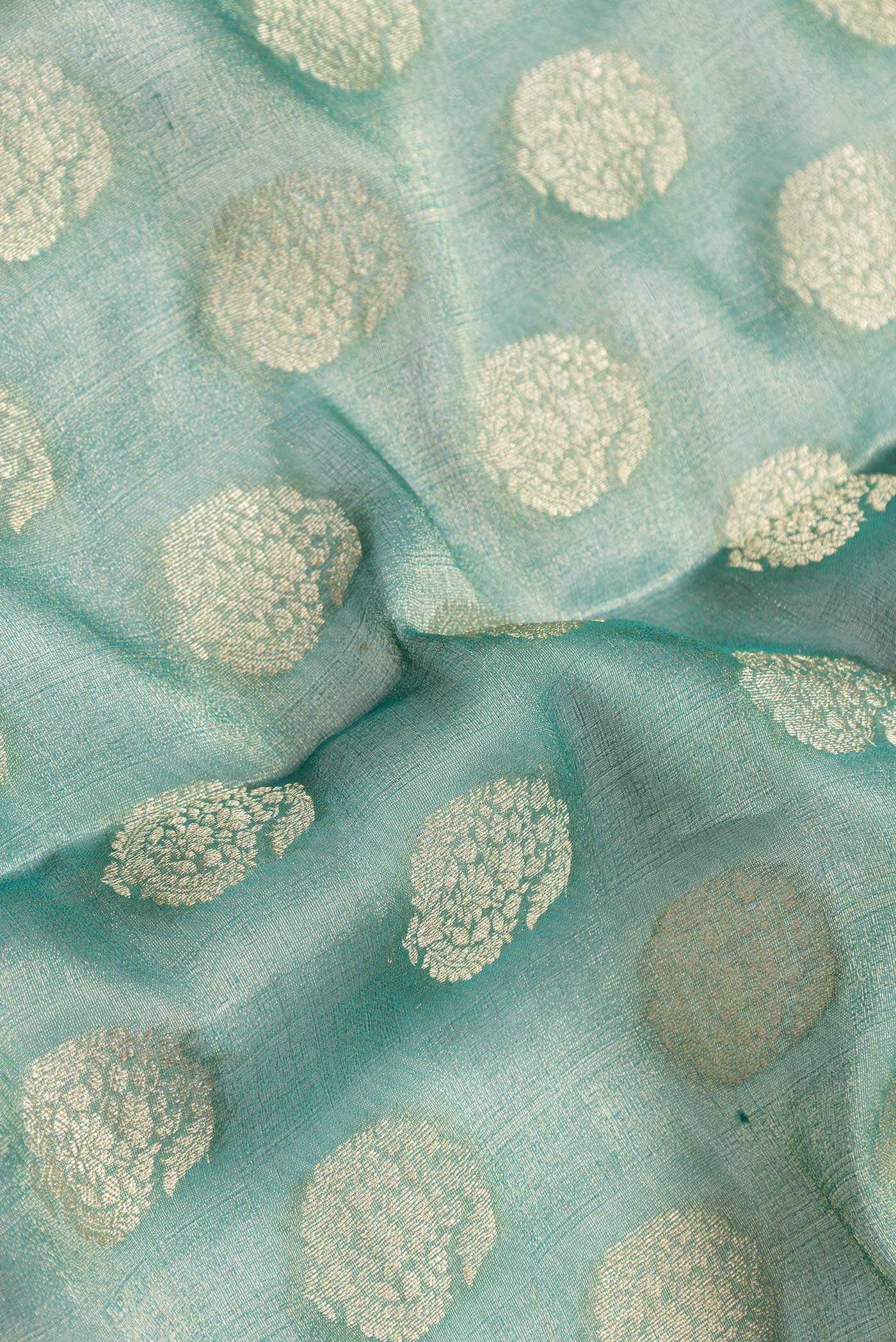 Close up of Sea Green Dual Tone Mysore Georgette Saree with Zari Brocade on the body and Zari Border.  displaying folds