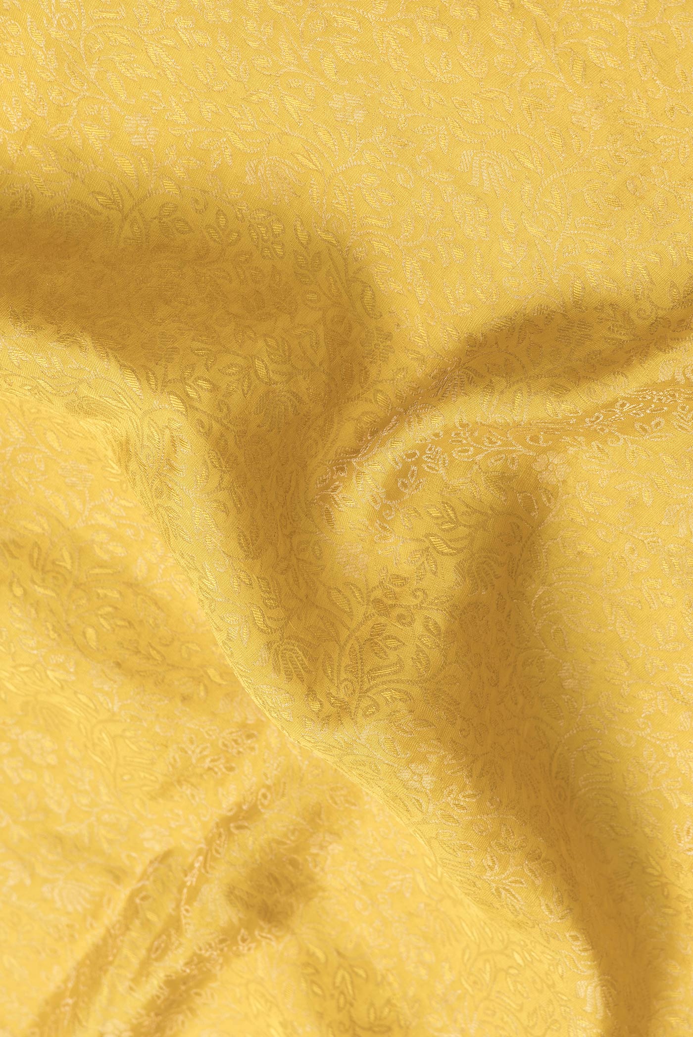 Close up of Yellow Dual Tone Georgette Saree with Zari Brocade on the body and Zari Border.  displaying folds