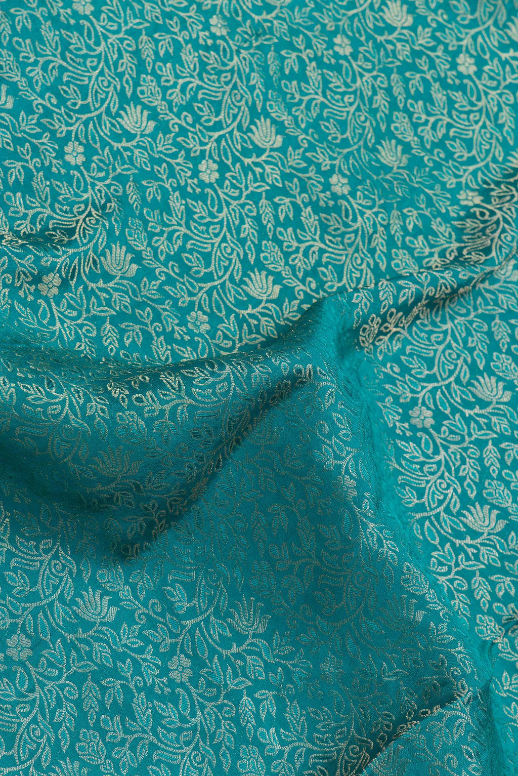 Close up of Sky Blue Dual Tone Georgette Saree with Zari Brocade on the body and Zari Border.  displaying folds