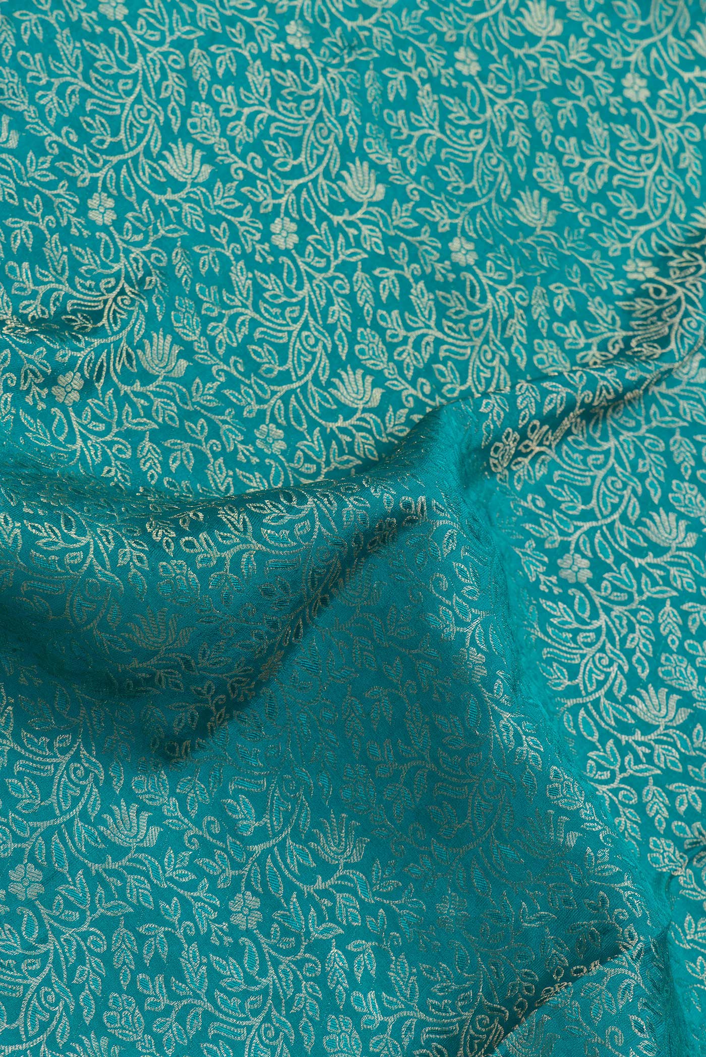 Close up of Sky Blue Dual Tone Georgette Saree with Zari Brocade on the body and Zari Border.  displaying folds