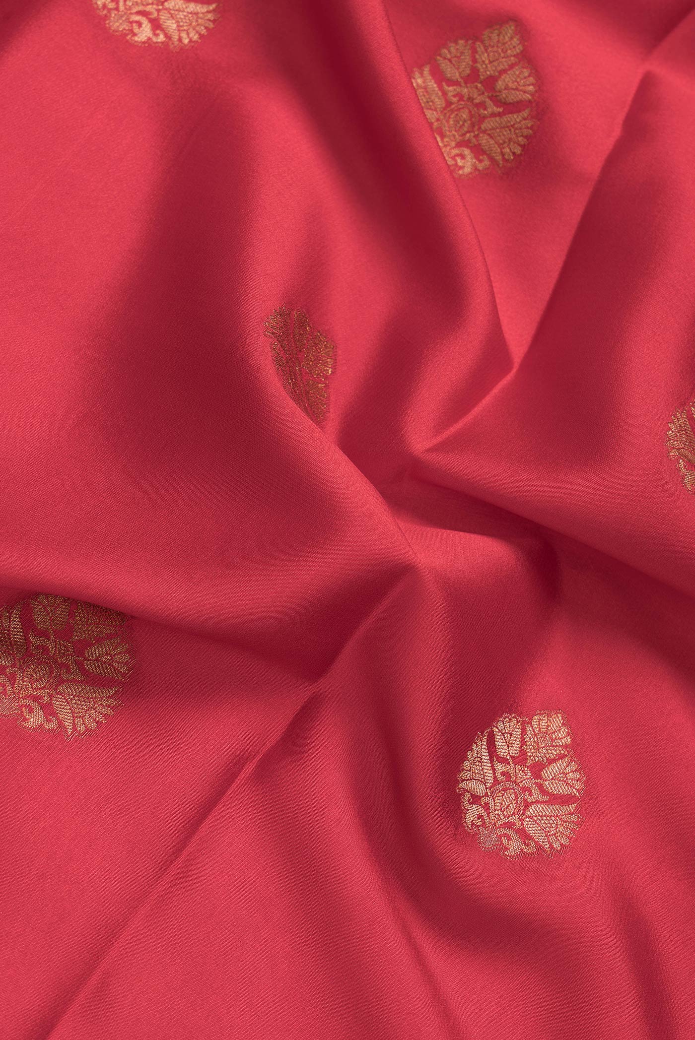 Close up of Red Dual Tone Mysore Silk Saree with Zari Butta on the body and Zari Border.  displaying folds