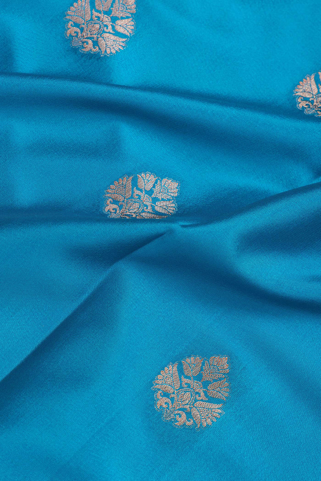 Close up of Sky Blue Dual Tone Mysore Silk Saree with Zari Butta on the body and Zari Border.  displaying folds