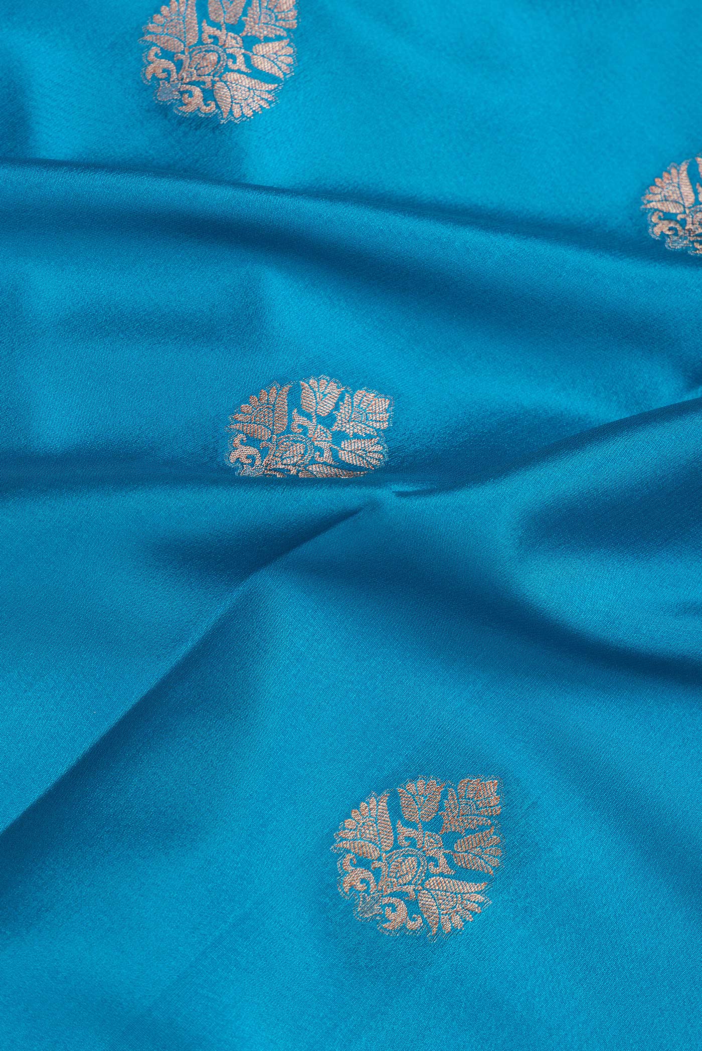 Close up of Sky Blue Dual Tone Mysore Silk Saree with Zari Butta on the body and Zari Border.  displaying folds