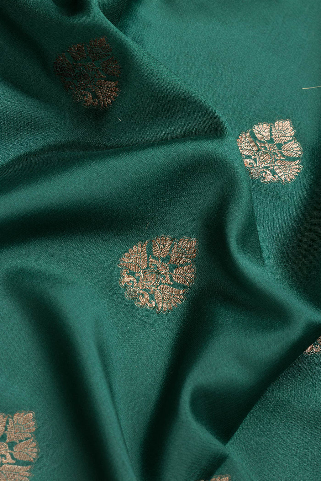 Close up of Bottle Green Dual Tone Mysore Silk Saree with Zari Butta on the body and Zari Border.  displaying folds