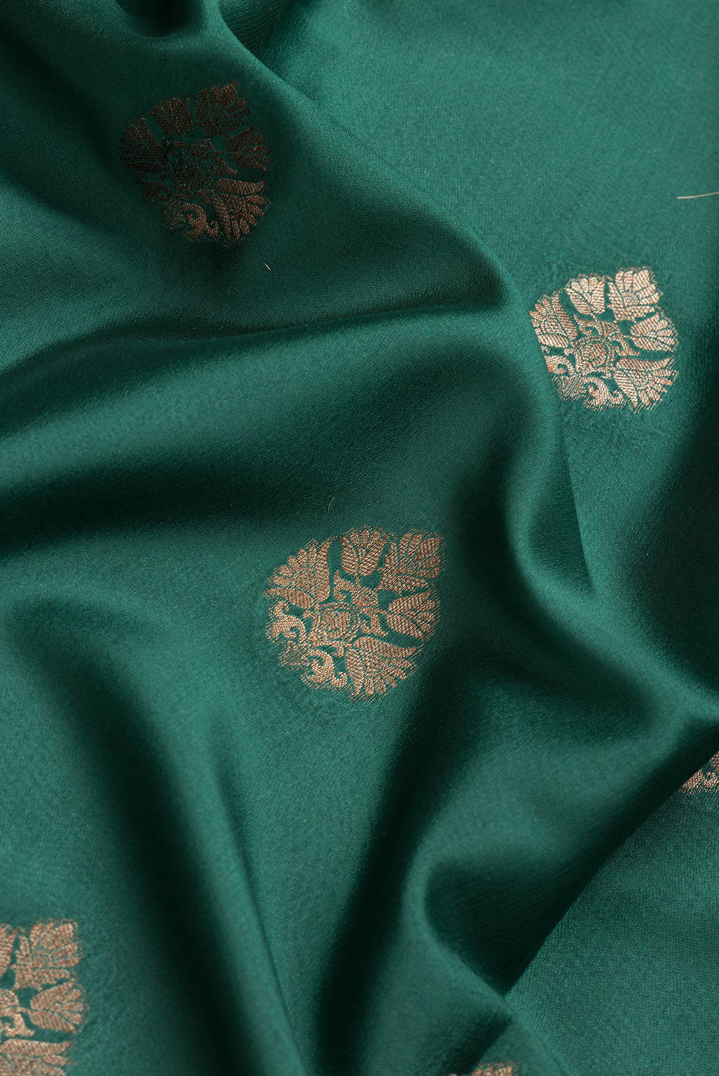 Close up of Bottle Green Dual Tone Mysore Silk Saree with Zari Butta on the body and Zari Border.  displaying folds