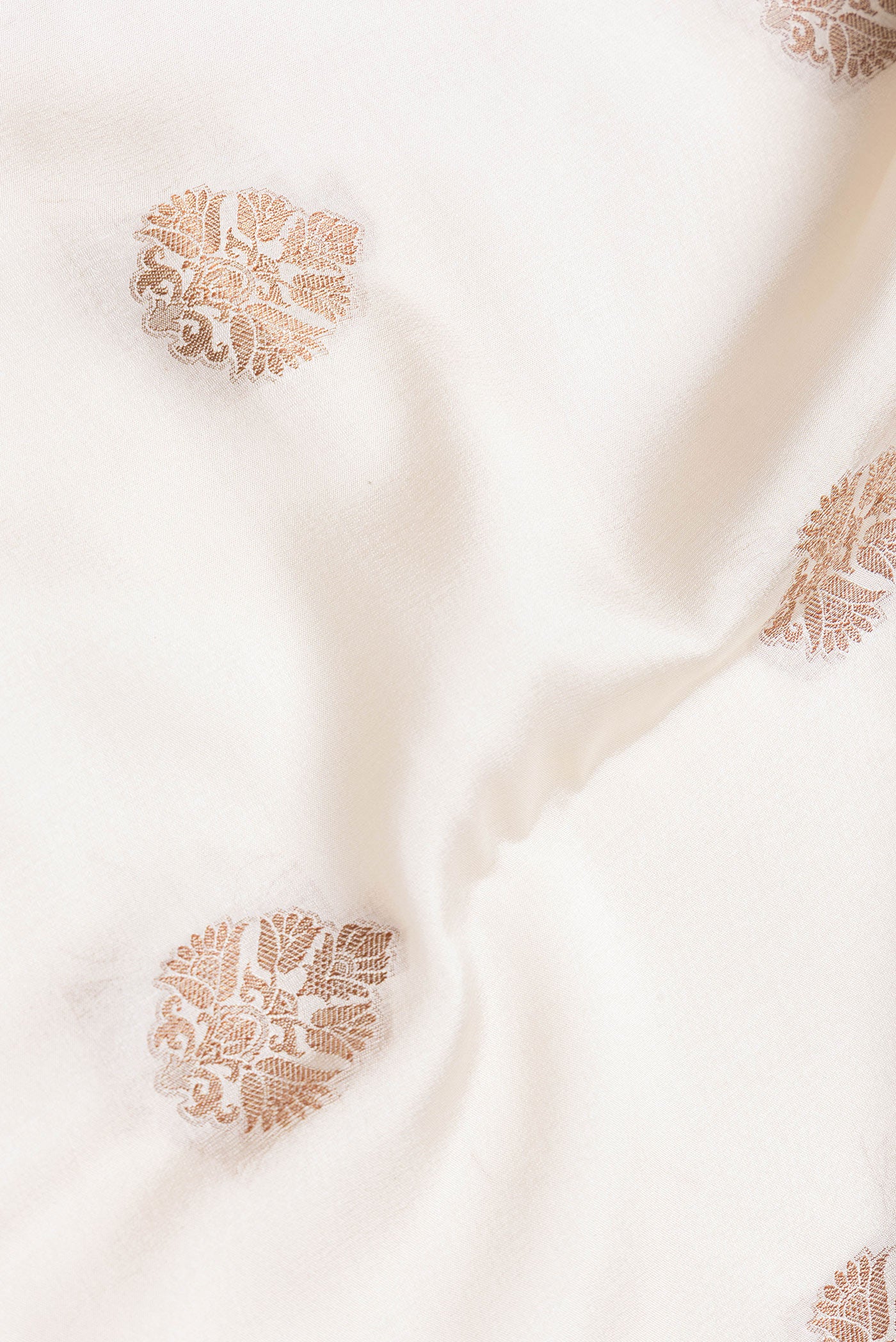 Close up of Beige Dual Tone Mysore Silk Saree with Zari Butta on the body and Zari Border.  displaying folds