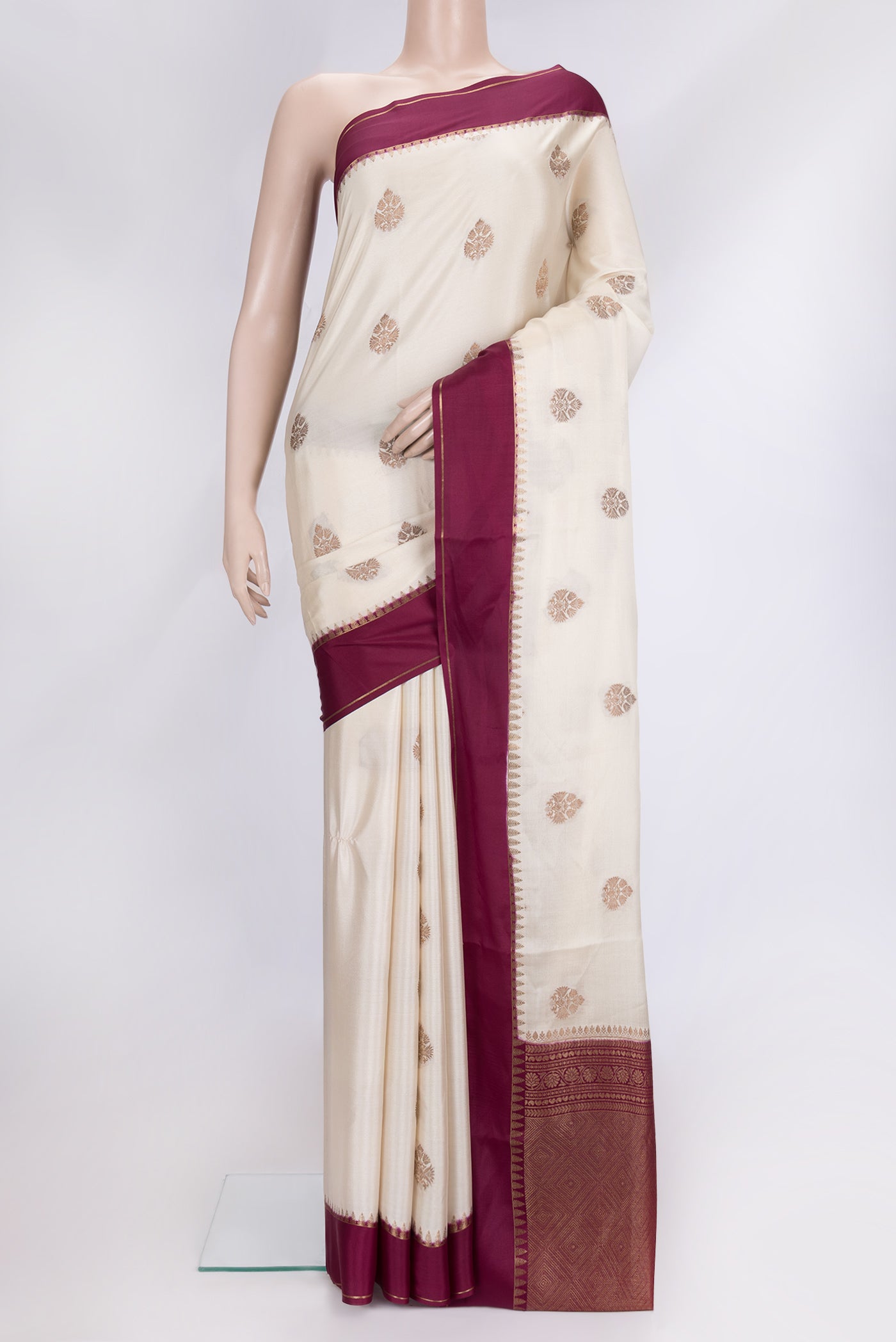 Beige Dual Tone Mysore Silk Saree with Zari Butta on the body and Zari Border.  displayed on a mannequin
