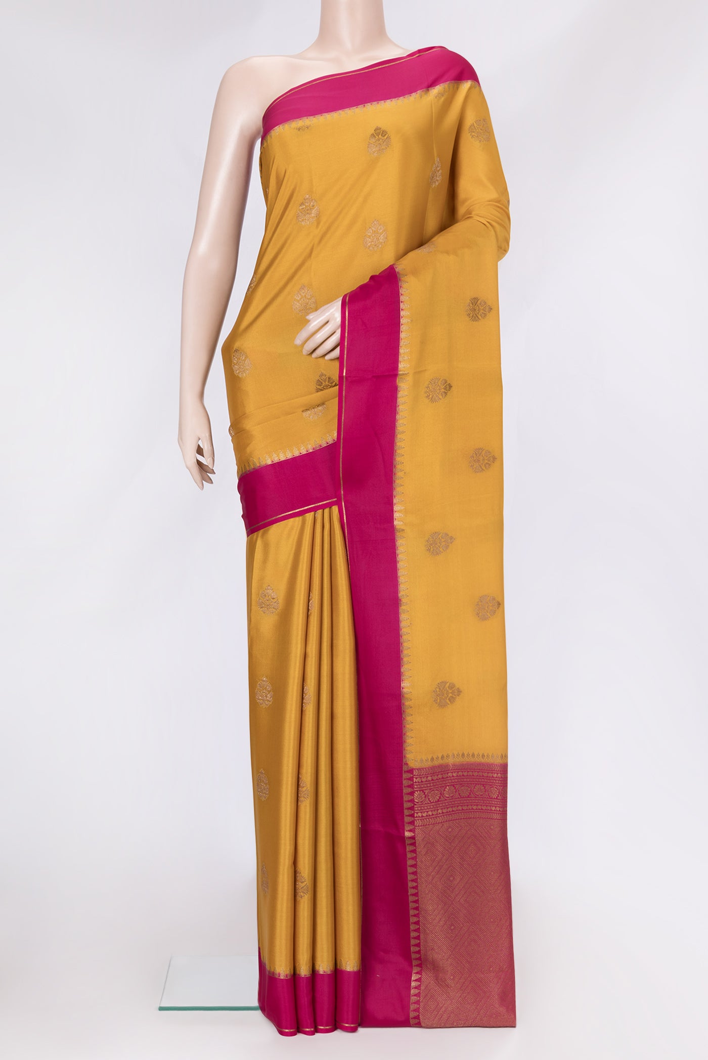 Mustard Dual Tone Mysore Silk Saree with Zari Butta on the body and Zari Border.  displayed on a mannequin