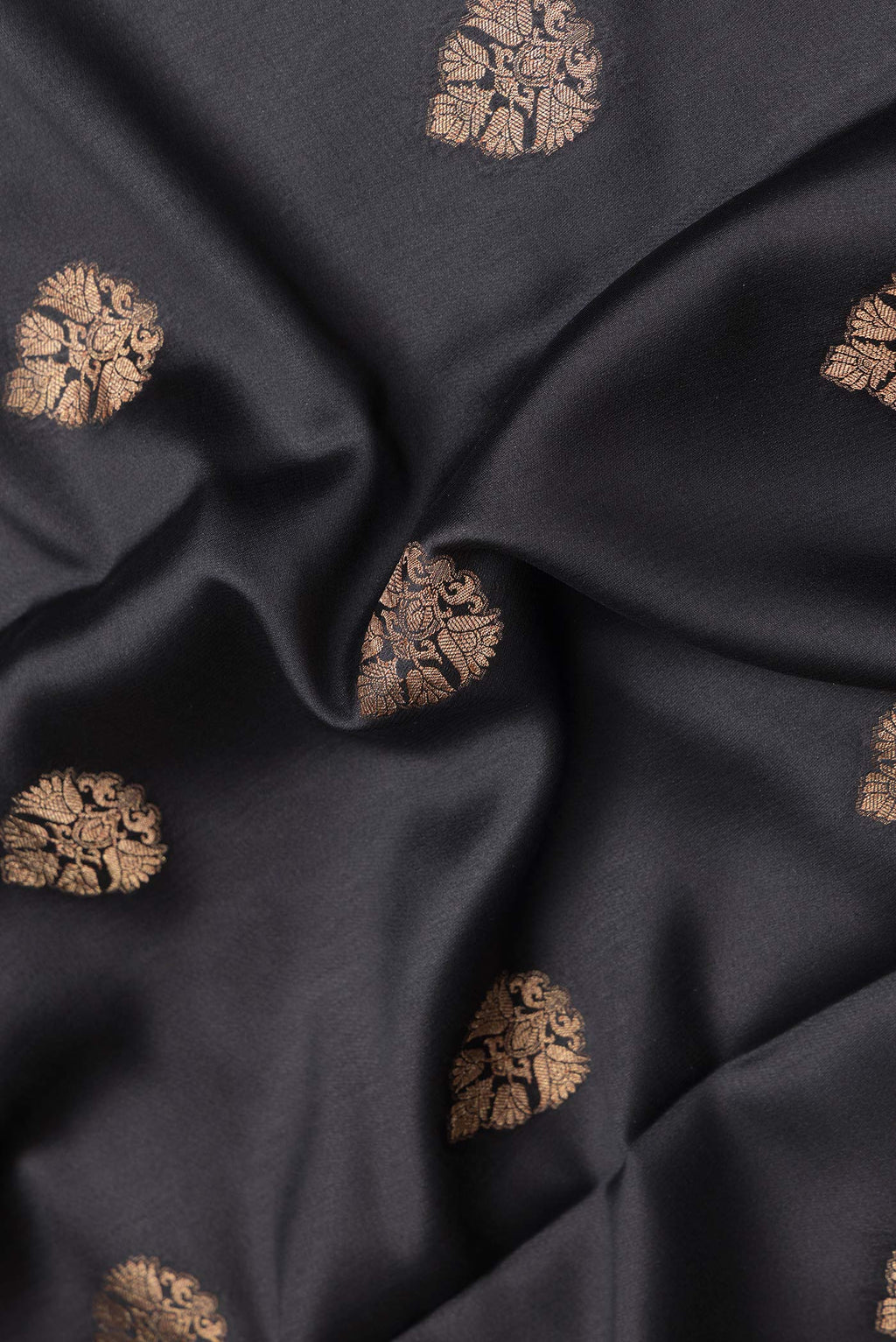 Close up of Black Dual Tone Mysore Silk Saree with Zari Butta on the body and Zari Border.  displaying folds
