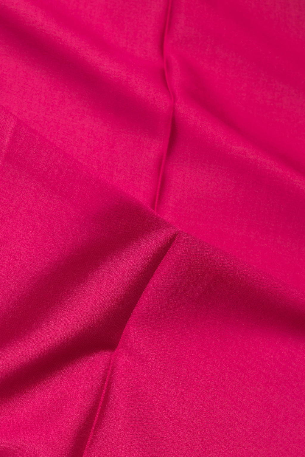 Close up of Pure Silk Dark Pink Mysore Crepe Saree with Plain Body and Zari Border.  displaying folds