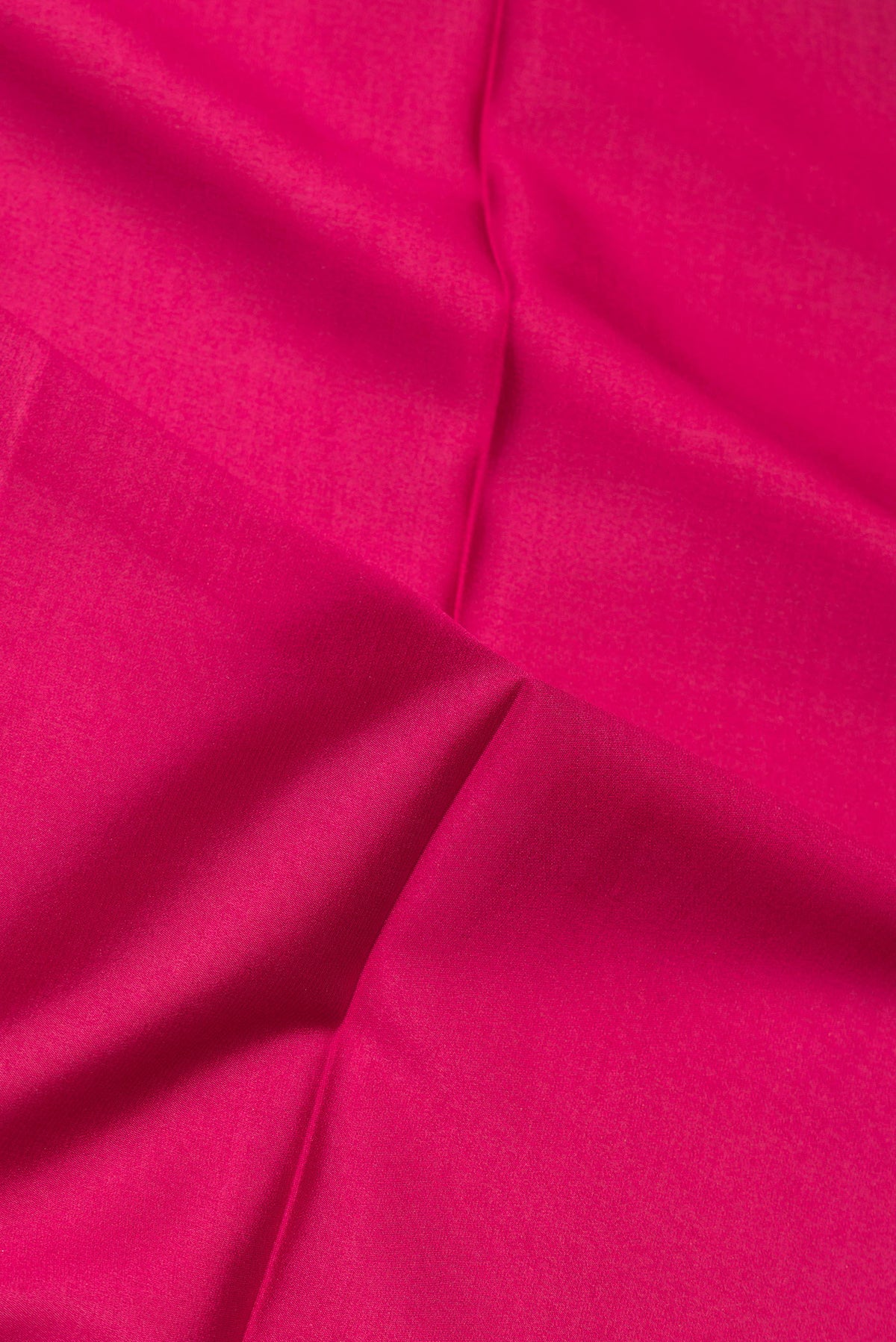 Close up of Pure Silk Dark Pink Mysore Crepe Saree with Plain Body and Zari Border.  displaying folds
