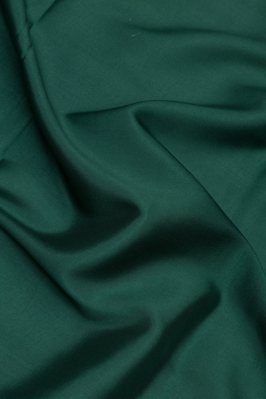Close up of Bottle Green Mysore Silk Saree with Plain Body and Zari Border.  displaying folds