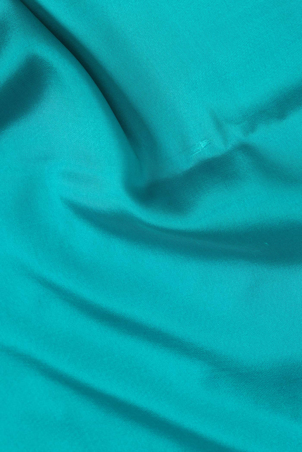 Close up of Sky Blue Dual Tone Mysore Silk Saree with Plain Body and Zari Border.  displaying folds