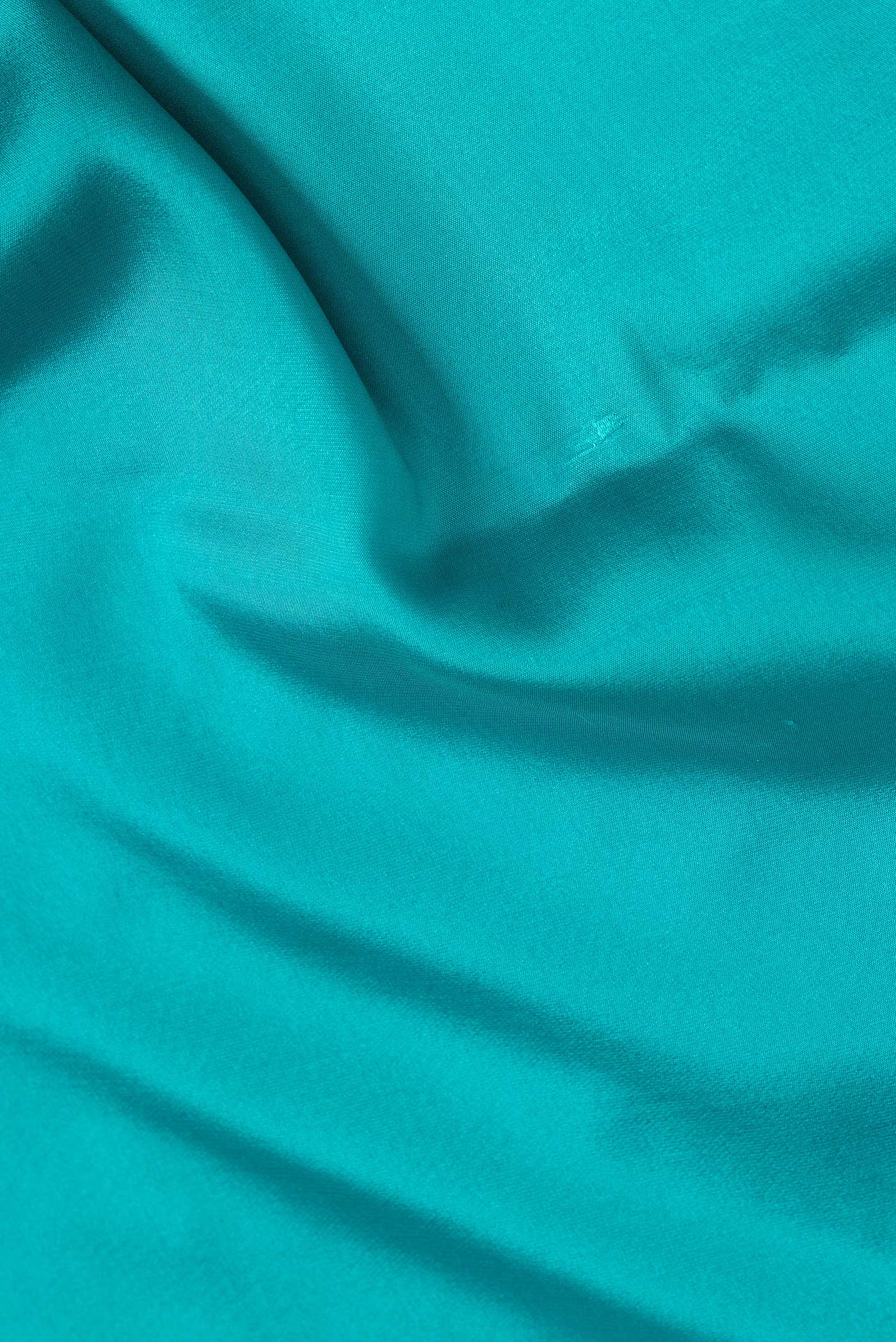 Close up of Sky Blue Dual Tone Mysore Silk Saree with Plain Body and Zari Border.  displaying folds