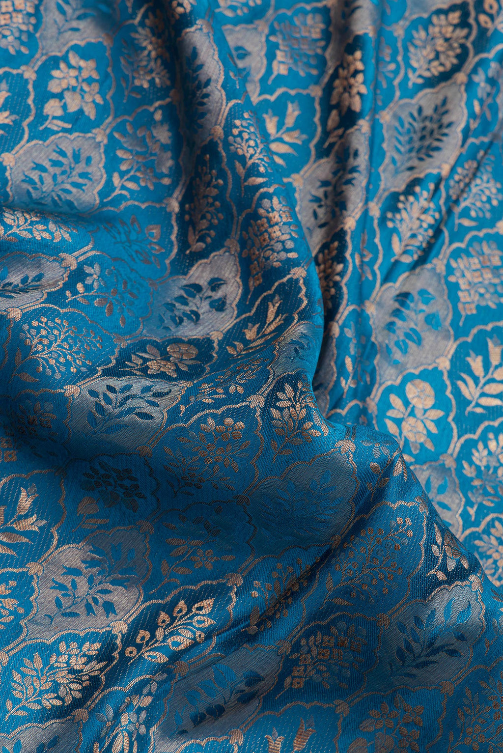Close up of Peacock Blue Mysore Crepe Saree with Zari Brocade on the body and Zari Border.  displaying folds