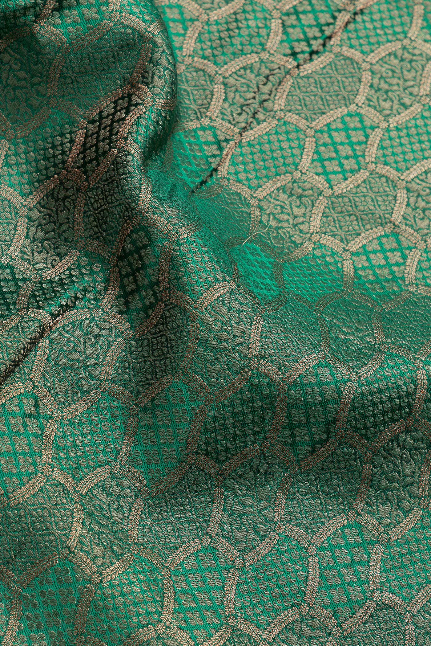 Close up of Bottle Green Dual Tone Georgette Saree with Zari Brocade on the body and Zari Border.  displaying folds