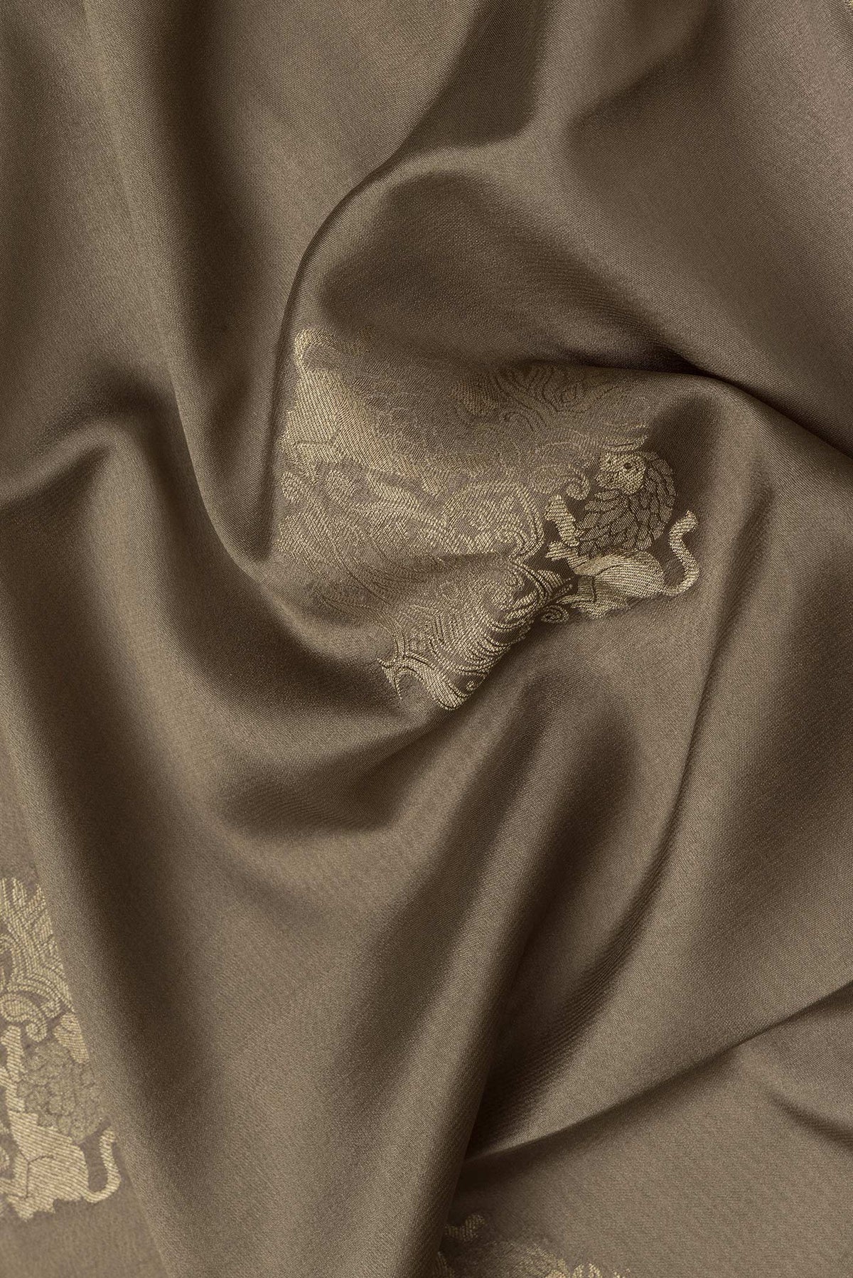 Close up of Mehandi Green Dual Tone Mysore Silk Saree with Zari Butta on the body and Zari Border.  displaying folds