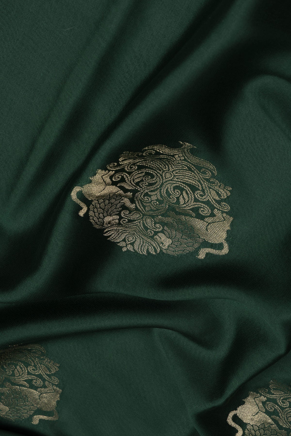 Close up of Bottle Green Dual Tone Mysore Silk Saree with Zari Butta on the body and Zari Border.  displaying folds