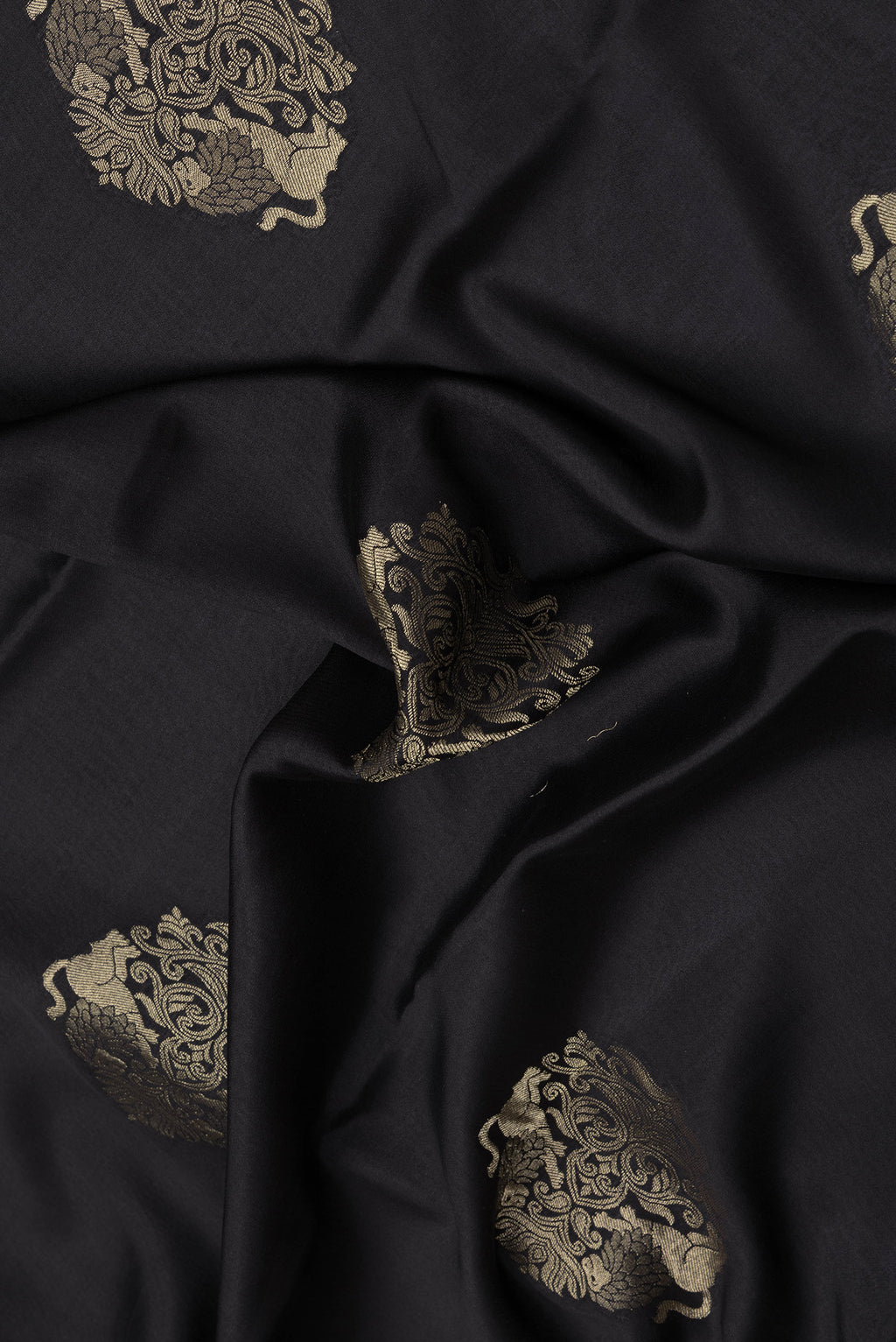 Close up of Black Dual Tone Mysore Silk Saree with Zari Butta on the body and Zari Border.  displaying folds