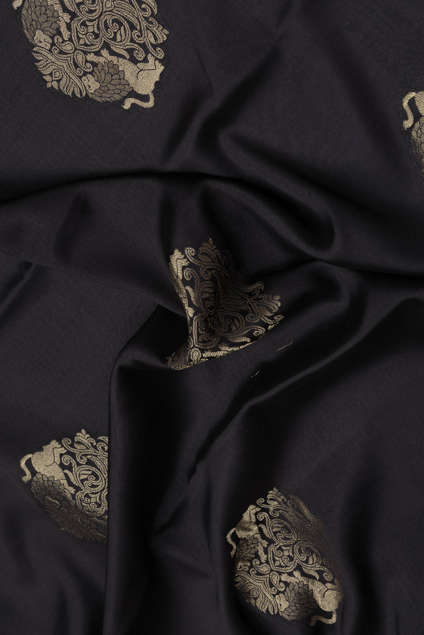 Close up of Black Dual Tone Mysore Silk Saree with Zari Butta on the body and Zari Border.  displaying folds
