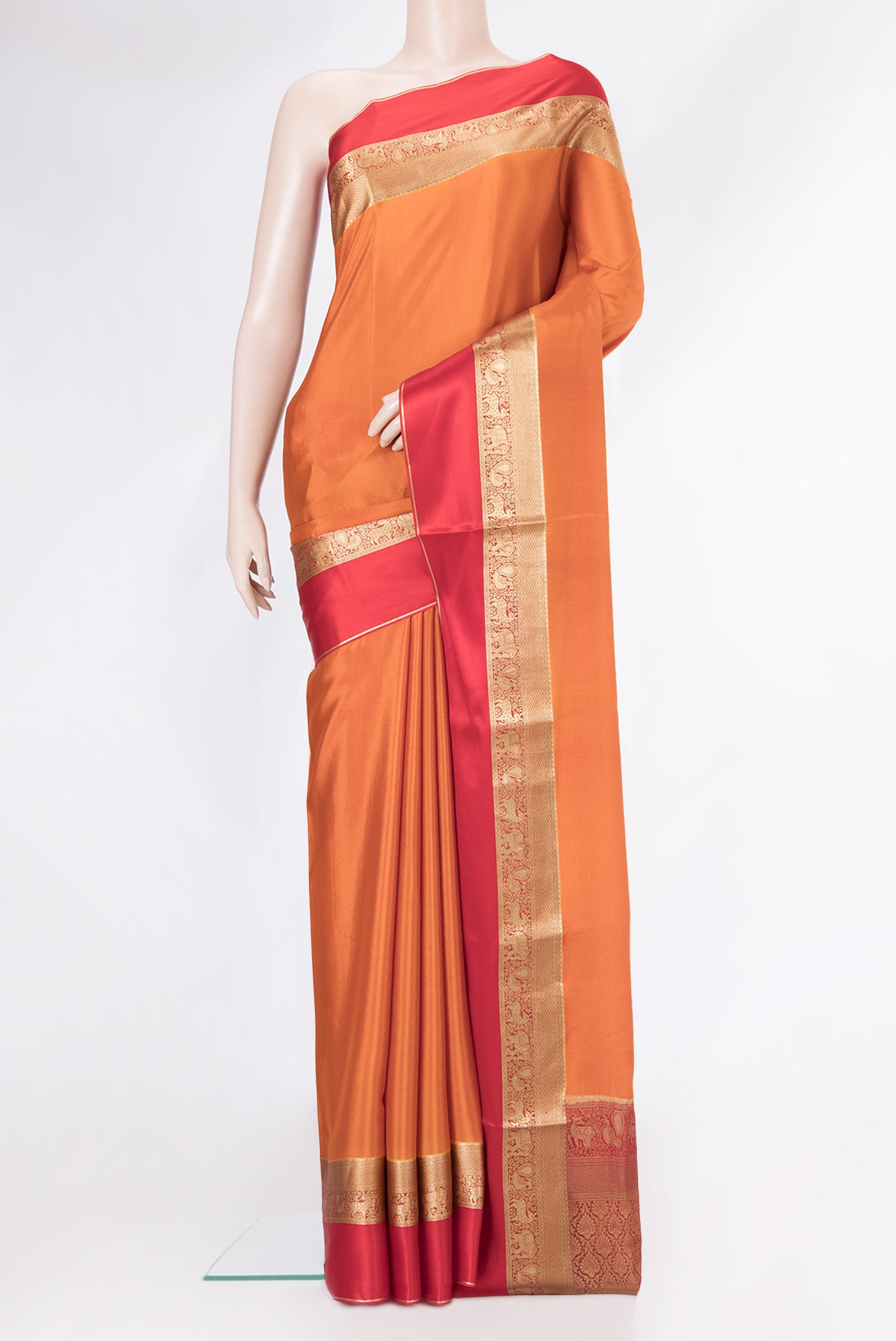 Brick Orange Mysore Crepe Saree with Plain Body and Zari Border.  displayed on a mannequin