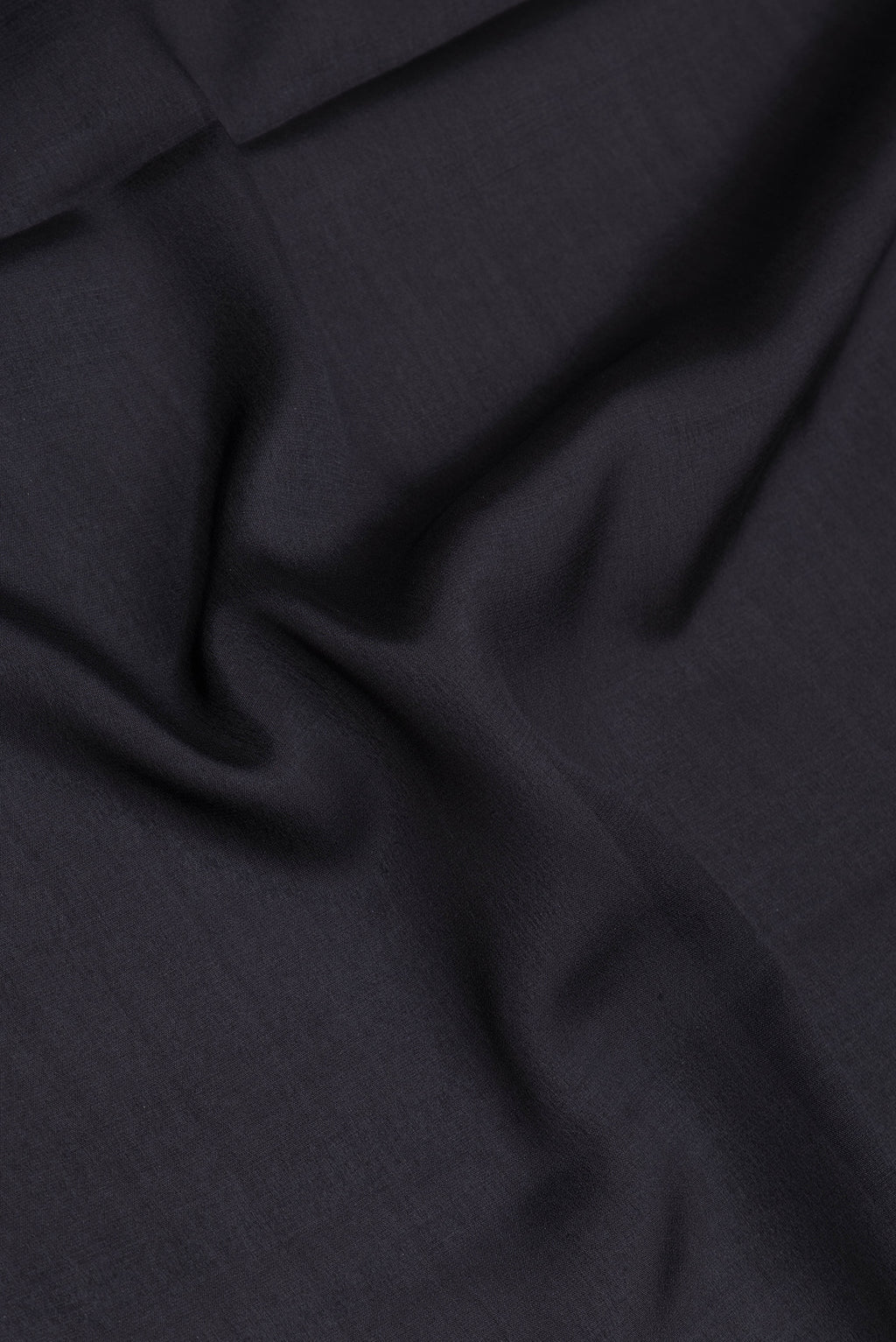 Close up of Black Mysore Silk Saree with Plain Body and Fancy Border.  displaying folds