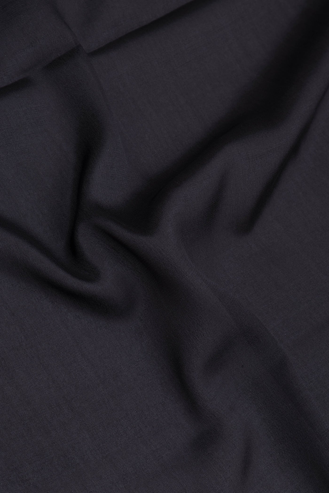 Close up of Black Mysore Silk Saree with Plain Body and Fancy Border.  displaying folds