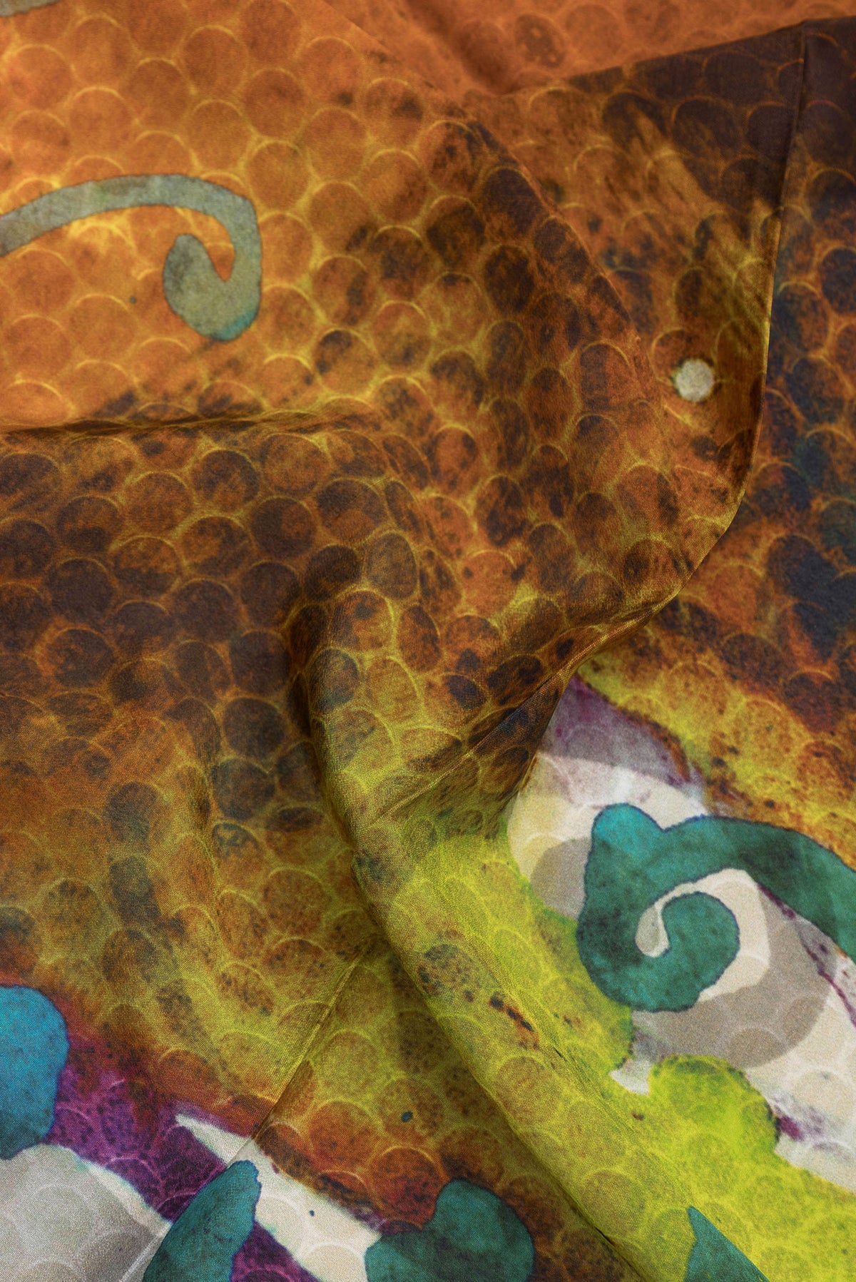 Close up of Multi Color Crepe Saree with Printed design on the body and Plain Border.  displaying folds