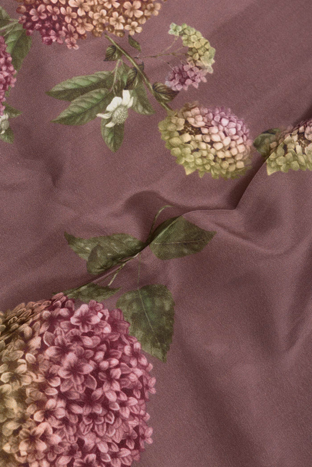 Close up of Brown Dual Tone Mysore Crepe Saree with Printed design on the body and Plain Border.  displaying folds
